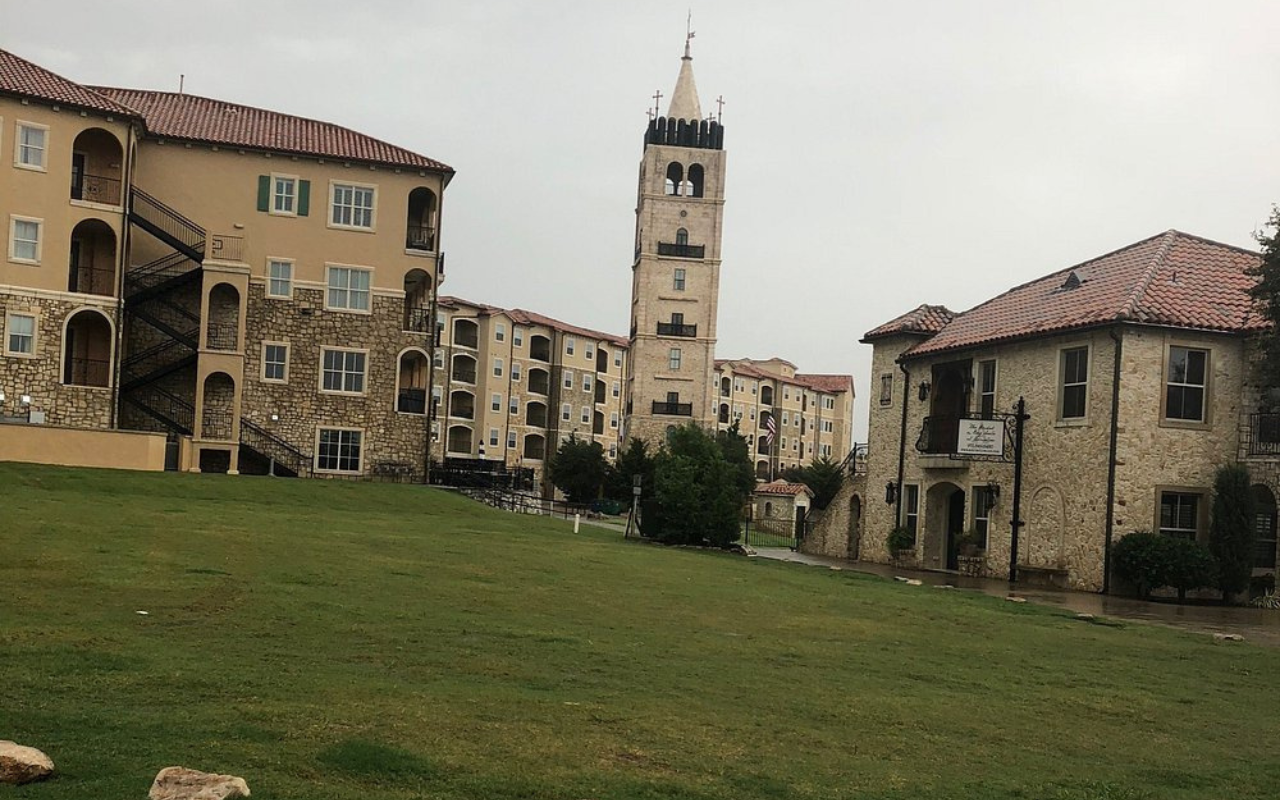 Mediterranean-style architecture with clock tower and stone buildings in Adriatica Village, Texas, a U.S. destination inspired by Croatia