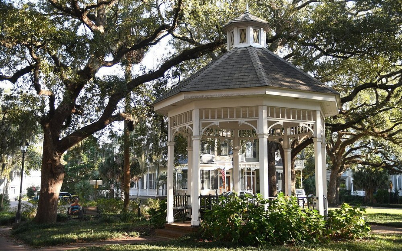 White gazebo in a tree-filled square in Savannah, Georgia, a U.S. city with historic charm similar to Dublin, Ireland