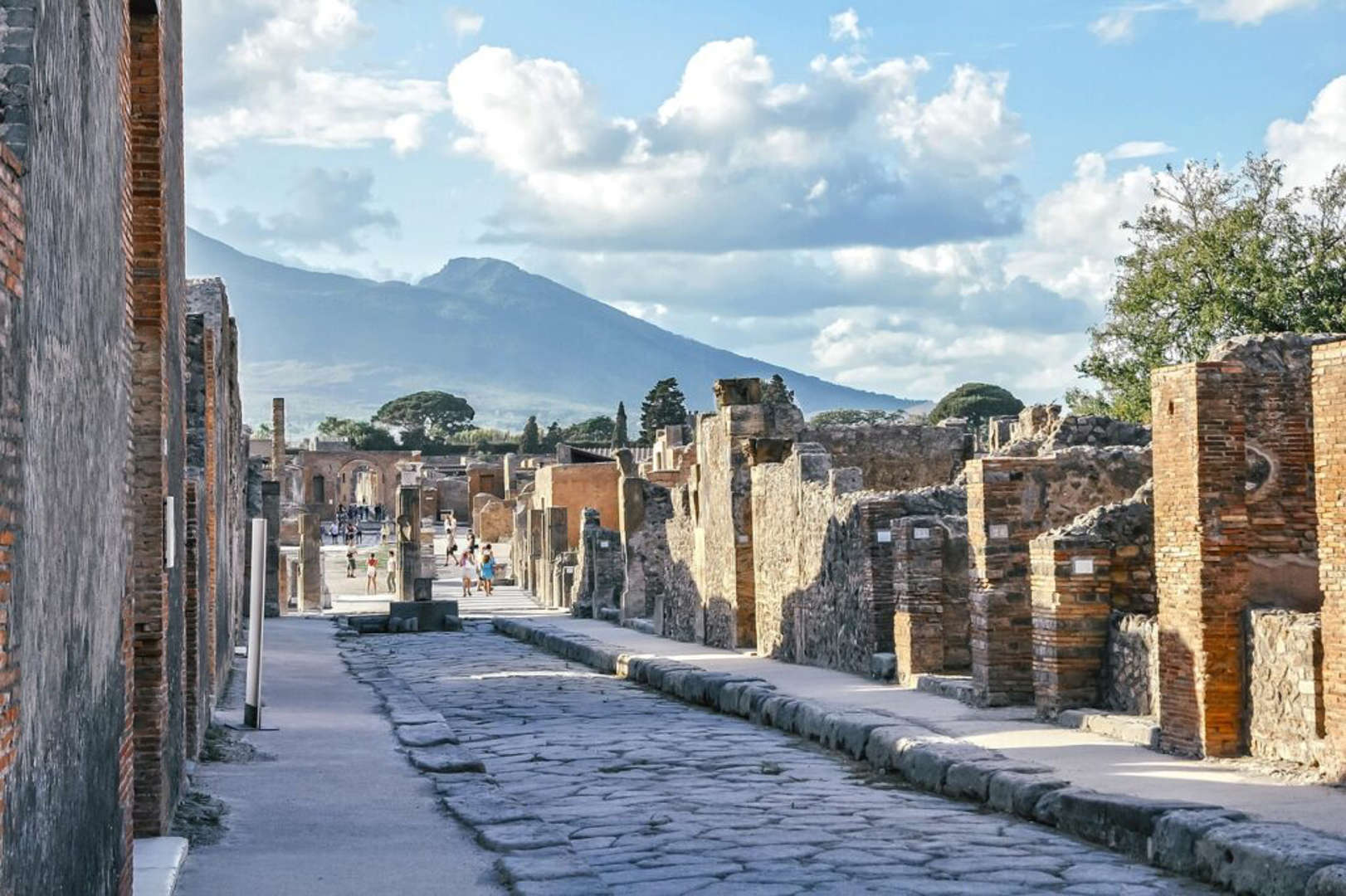 Ancient ruins of Pompeii with Mount Vesuvius in the distance.