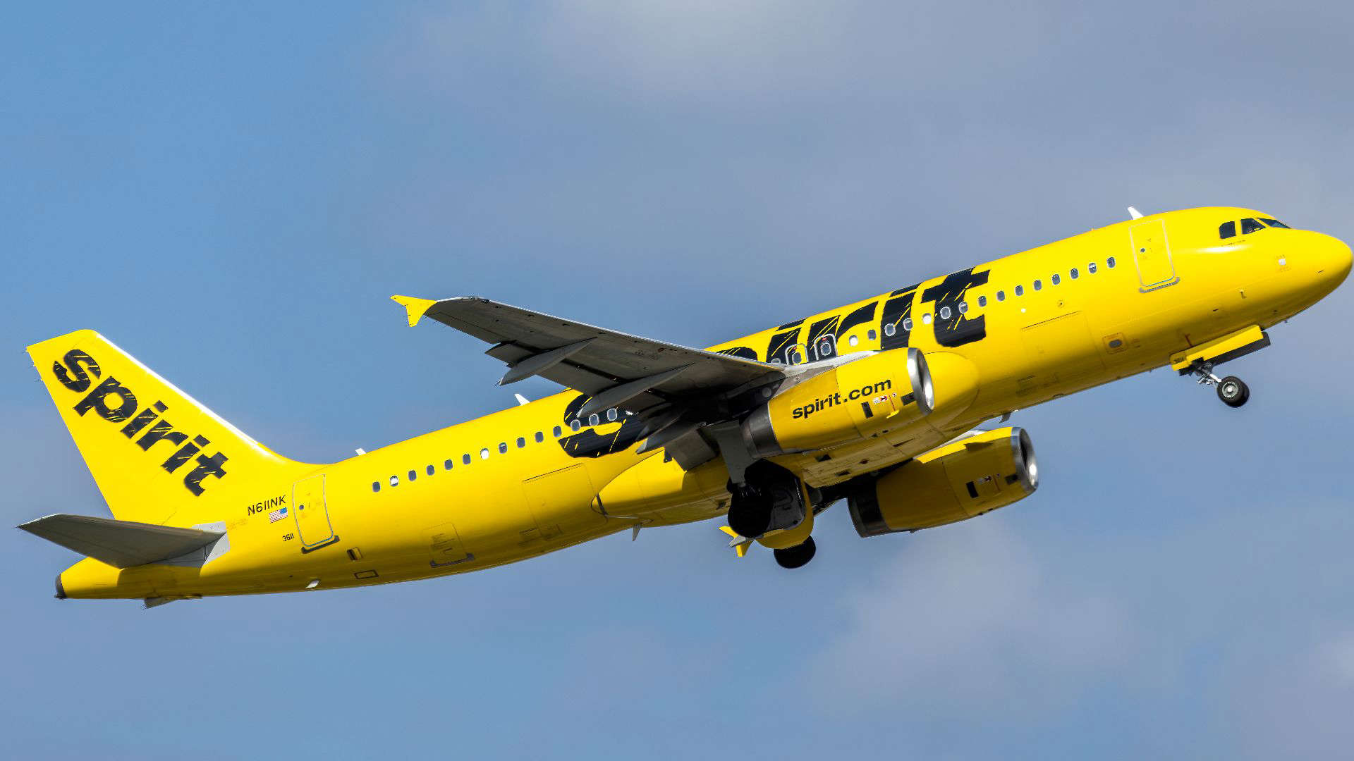 Bright yellow Spirit Airlines plane taking off, representing the low-cost carrier often noted for poor flight crew service.