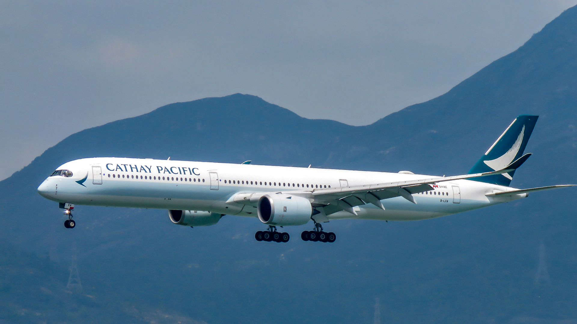 Cathay Pacific aircraft in flight, highlighting the airline’s world-class cabin crew and reputation for attentive, caring service.