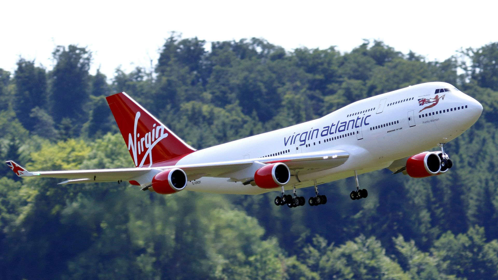 Virgin Atlantic airplane in flight, showcasing the airline’s stylish design and reputation for friendly, upbeat cabin crew service.