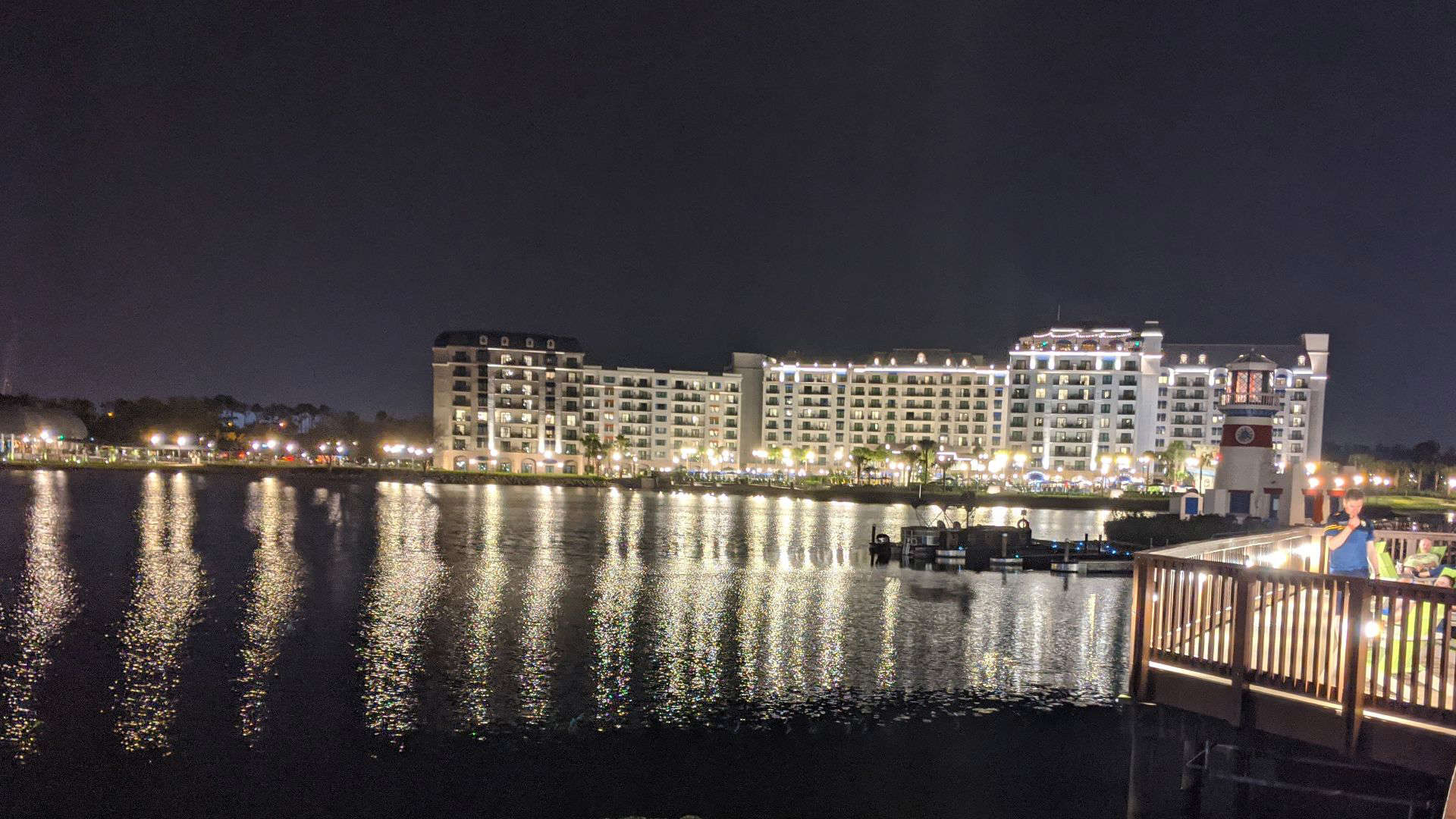 Disney’s Riviera Resort at night with waterfront reflections, an overhyped Disney World hotel that lacks immersive theming despite its Skyliner access