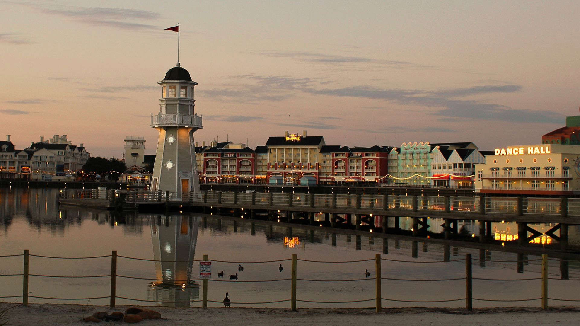Disney’s Beach Club Resort lighthouse and waterfront at sunset with reflections on the lake – an overhyped Disney World hotel review highlighting better resort picks.