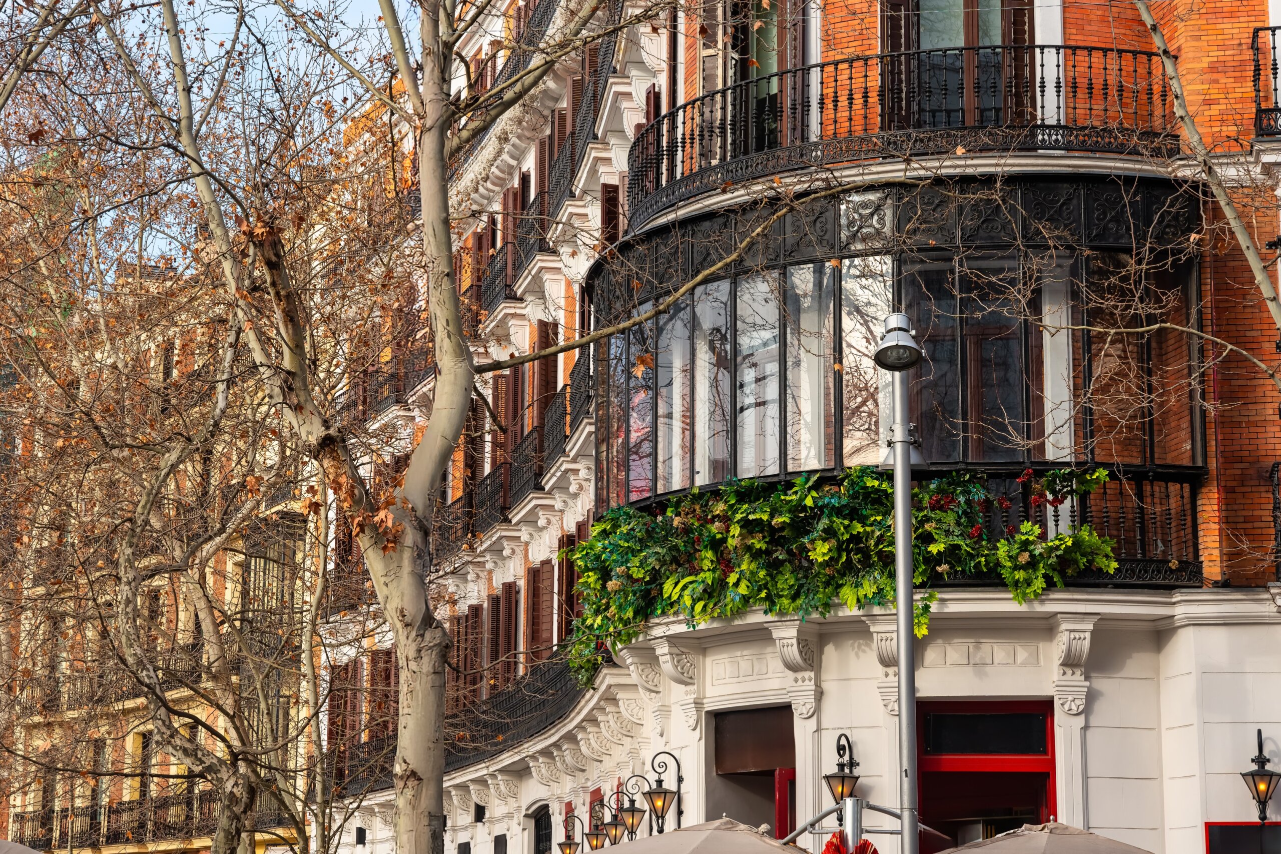 Facades of classic buildings on Madrid's Calle Serrano, a luxury shopping area.