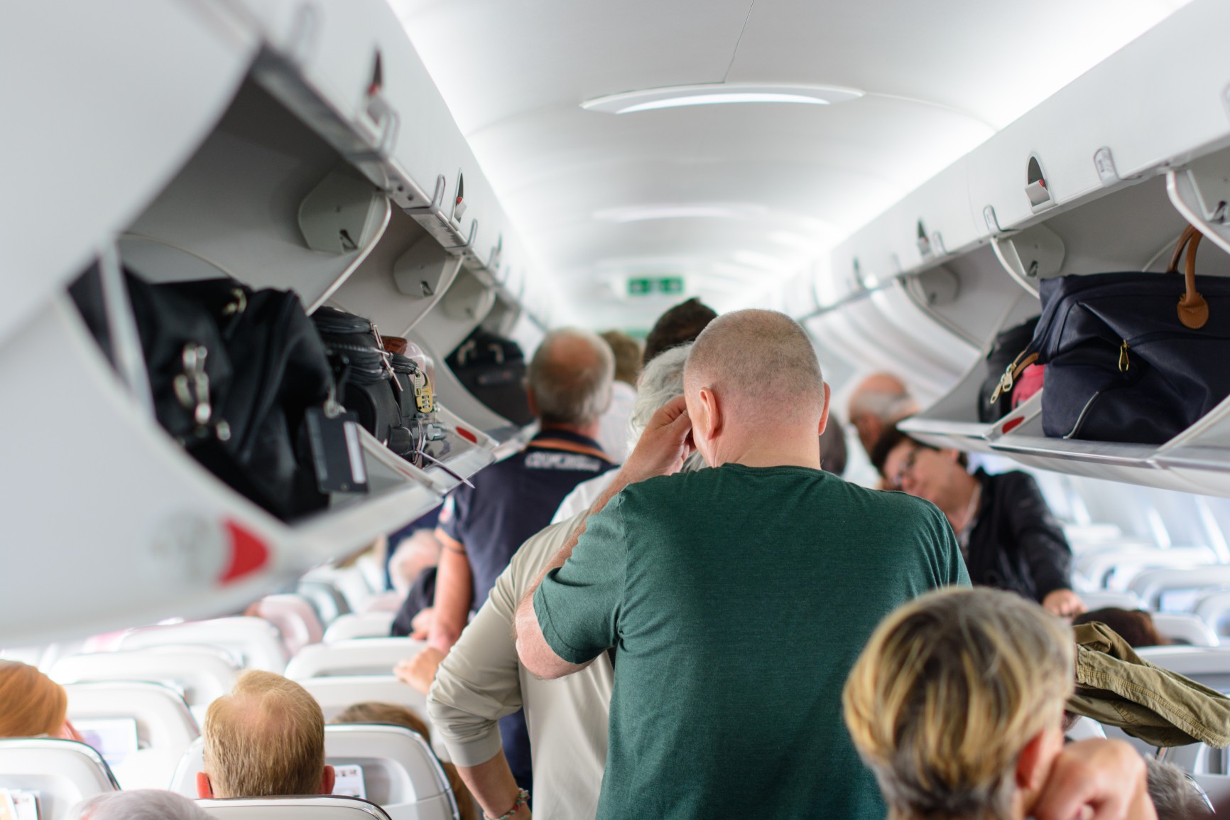 People waiting to leave the airplane
