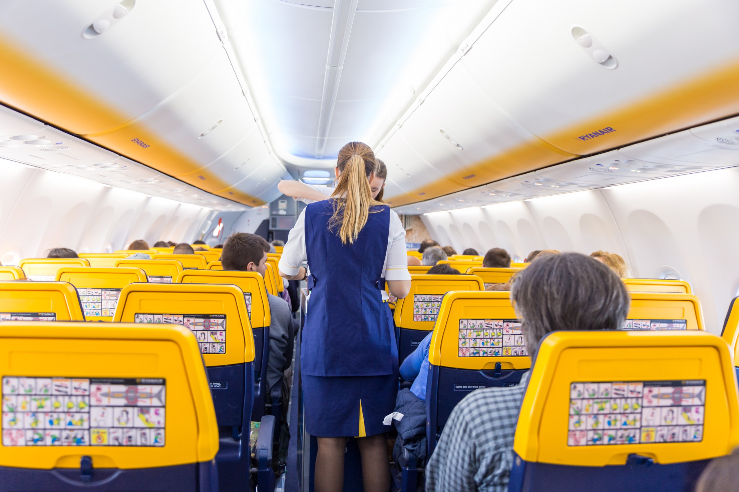 Interior view of stewardess serving passengers on Ryanair low-cost flight on 14th of December 2017 on a flight from Trieste to Valencia.