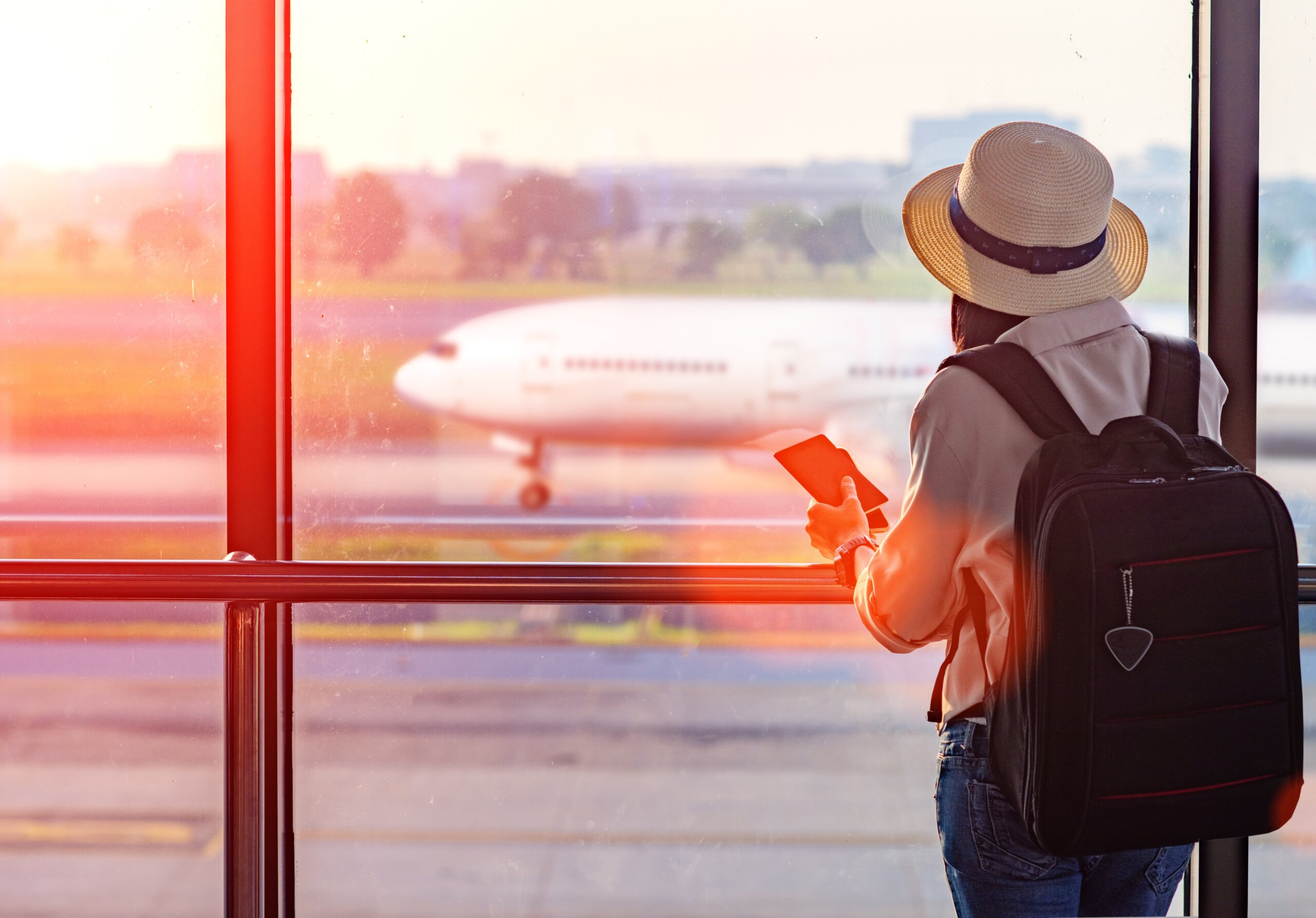 Woman holding passport waiting in transit area in the airport, standing by for the next schedule traveling, late delay of the arrival departure, missing checking in the boarding pass