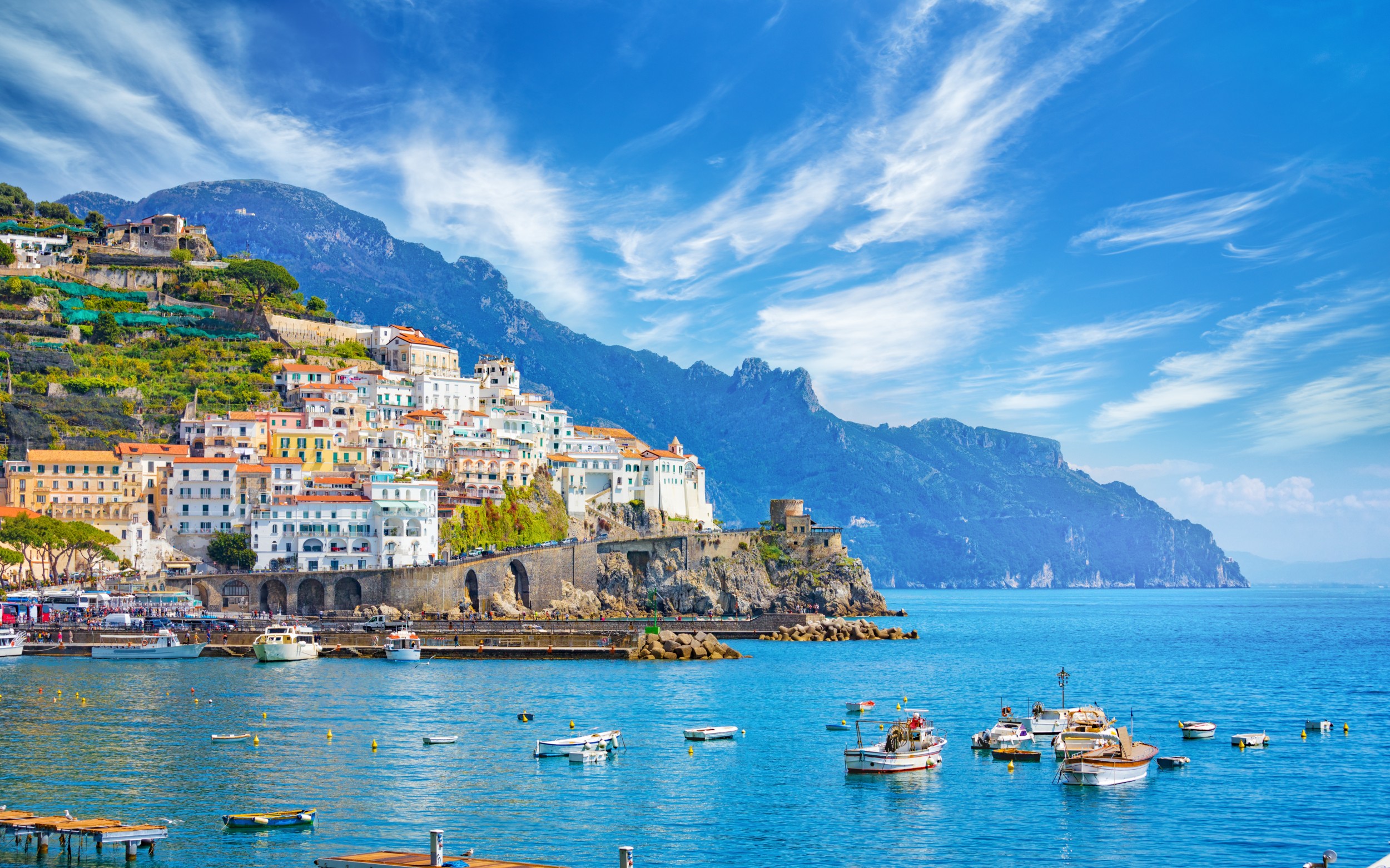 Beautiful Amalfi on hills leading down to coast, comfortable beaches and azure sea on Amalfi Coast in Campania, Italy