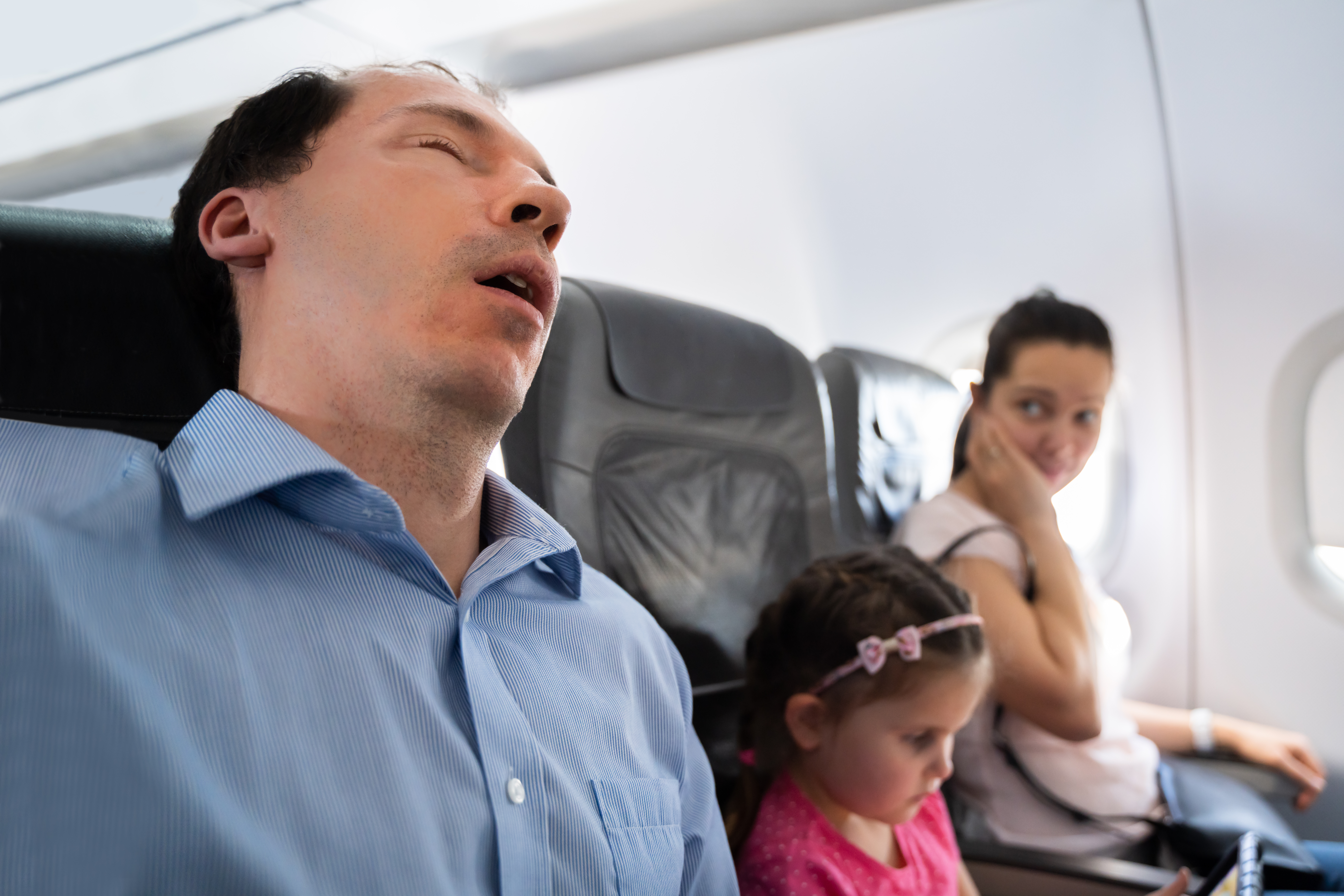 Father Snoring Loud While Sleeping in Airplane
