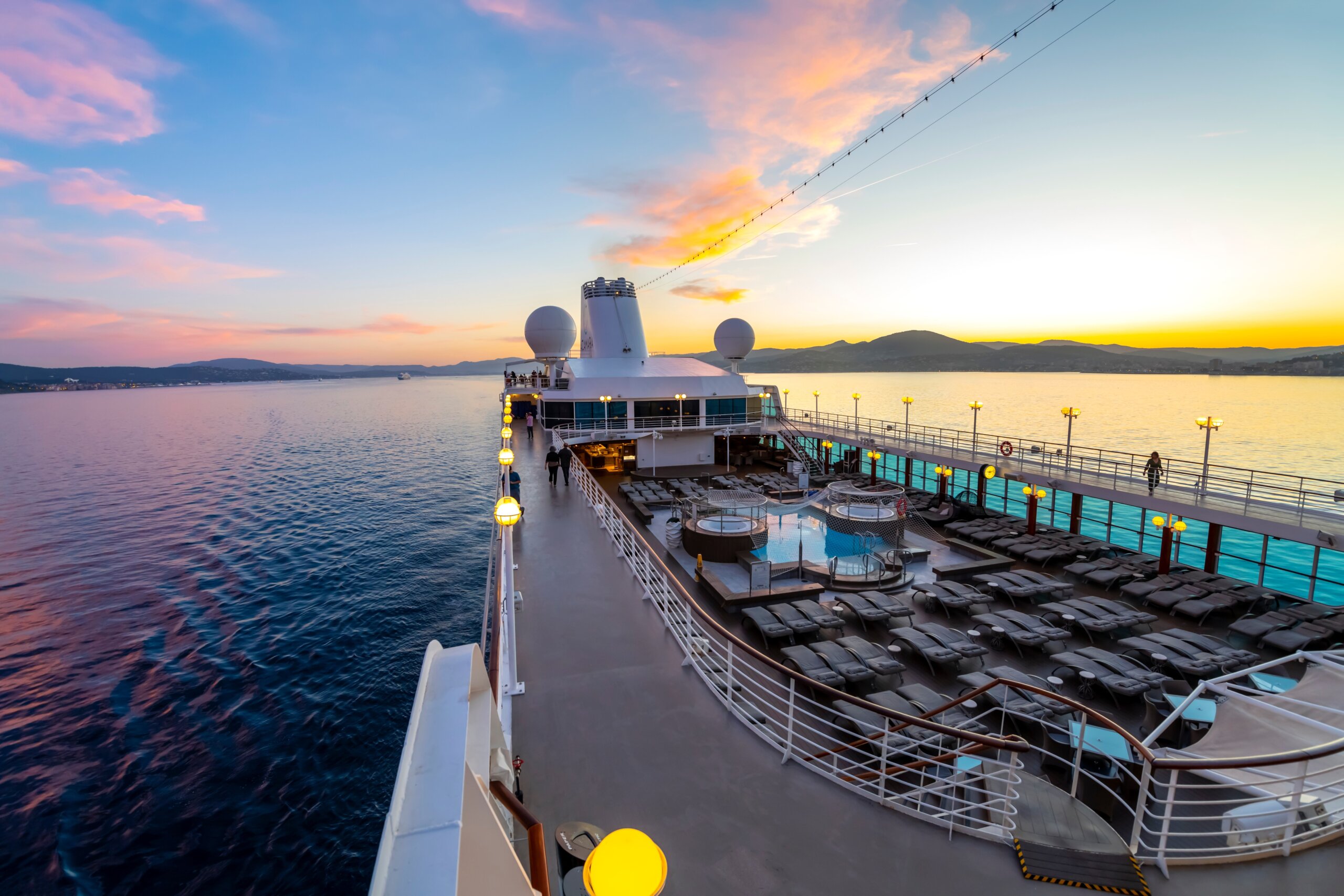 Deck view of the upper level and pool area of the Azamara Quest cruise ship at sunset on the Mediterranean Sea near Saint-Tropez, France