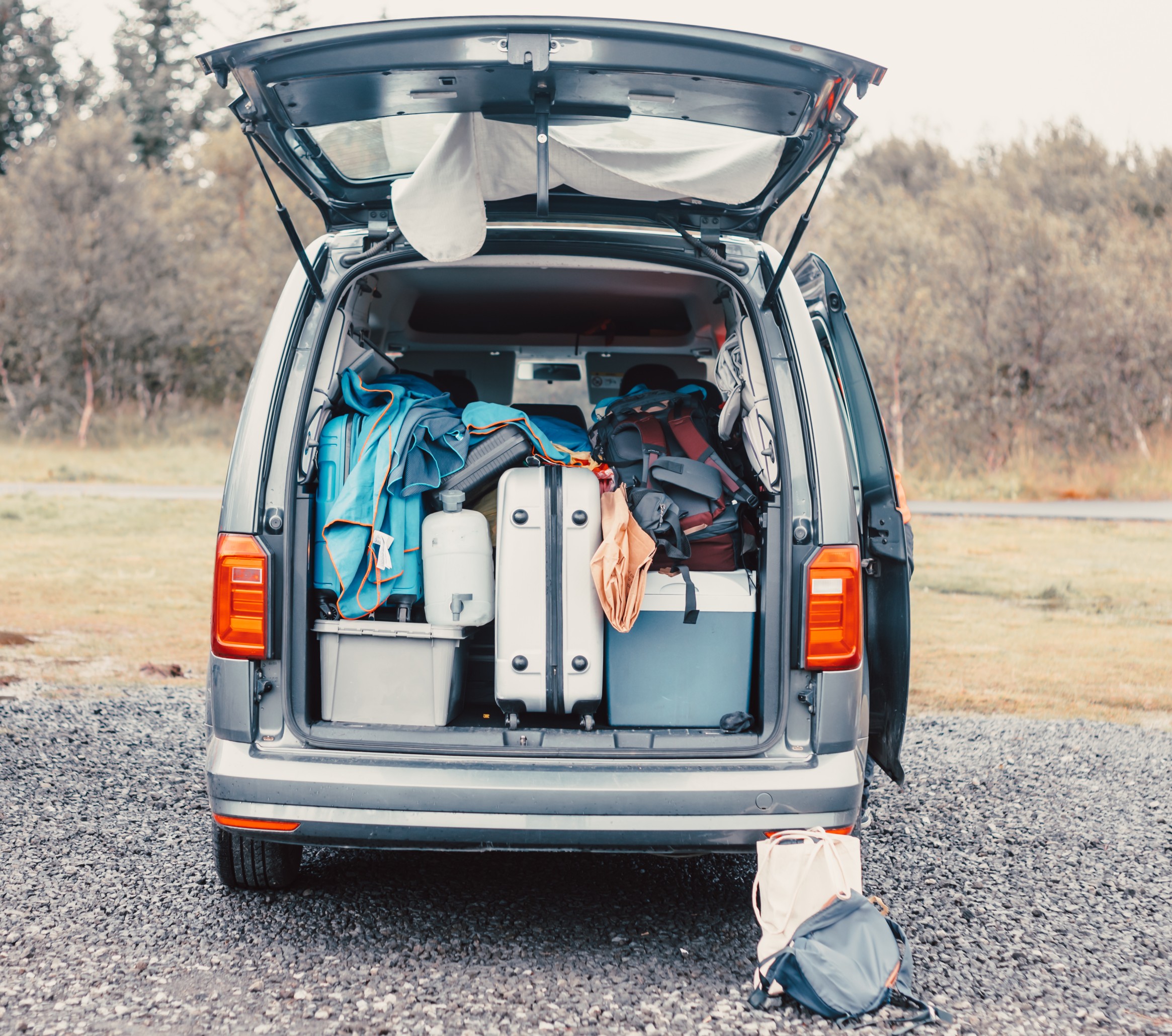 Traveling van filled with suitcase, bag and road trip stuff ready to start the route traveling across Iceland. Sleeping outdoors, camping and exploring concepts.