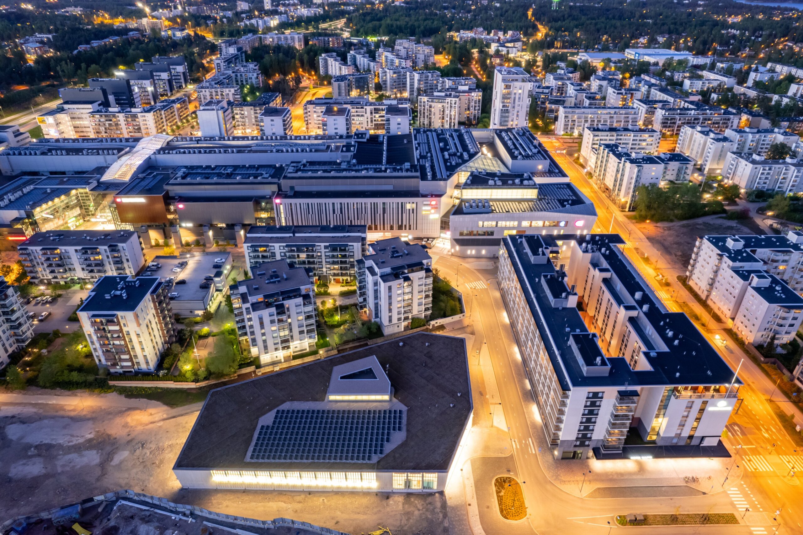 Aerial view of Espoo’s Matinkylä district in Finland with modern Nordic buildings and rooftop solar panels.