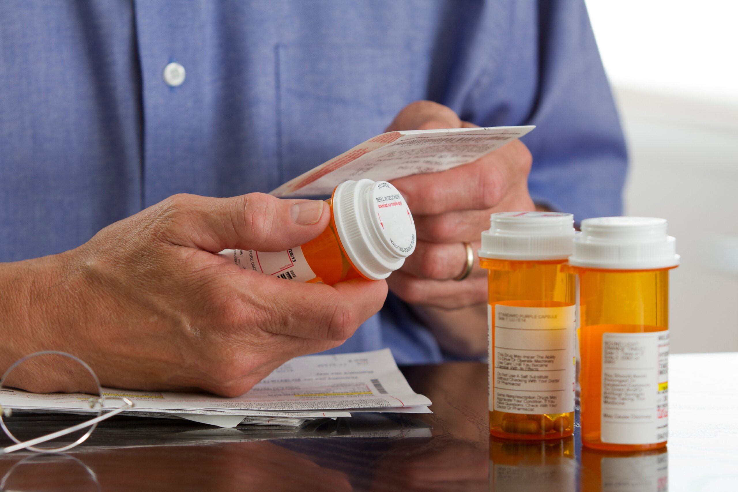 Older man with prescription medications, horizontal
