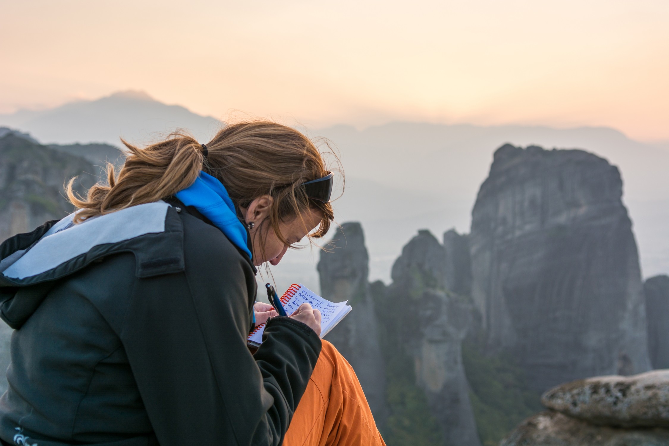 Girl writing her thoughts while traveling the world