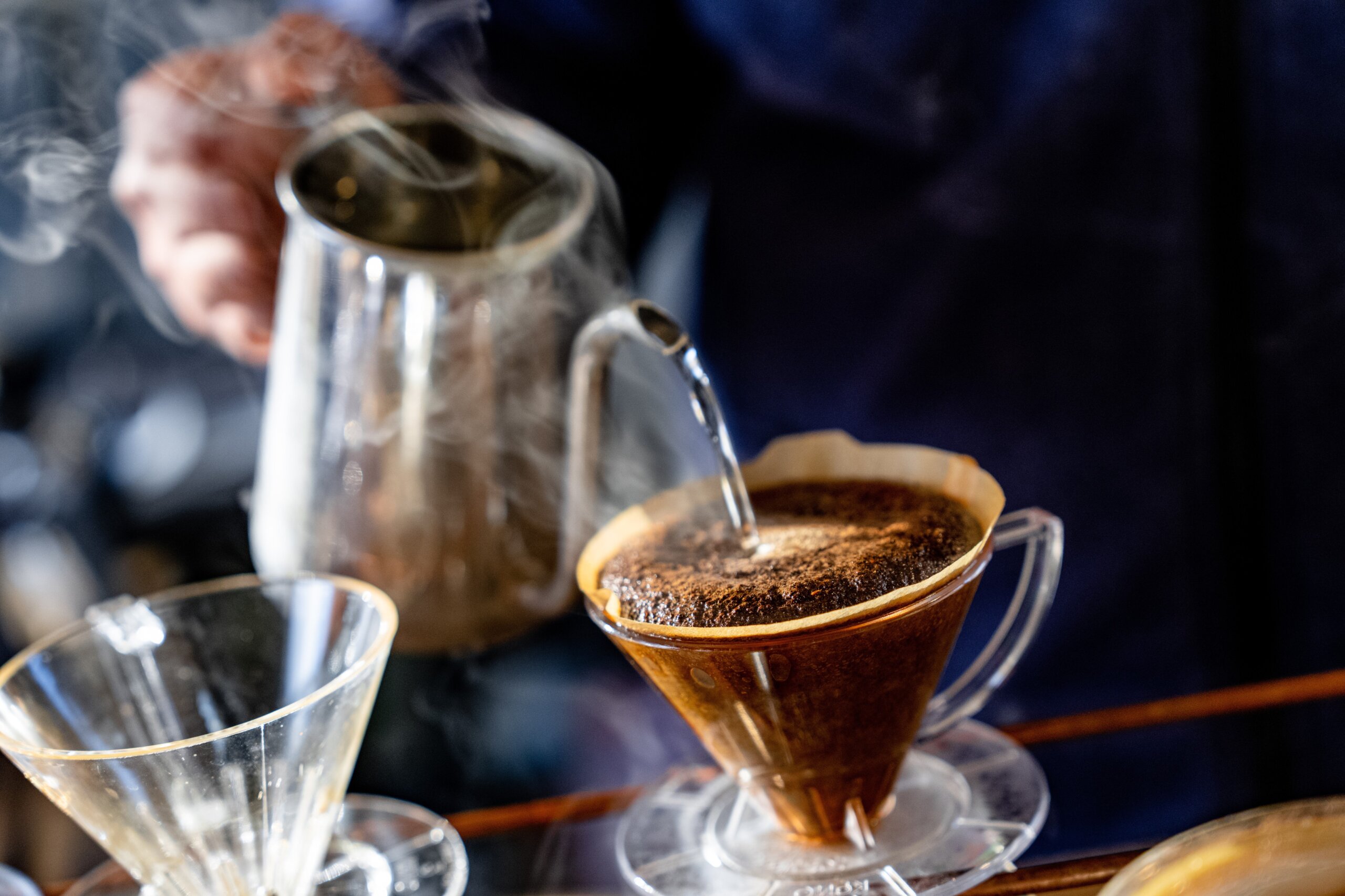 Steam rises from a pour-over coffee in a school bus cafe in Fujikawaguchiko, Japan, during winter.