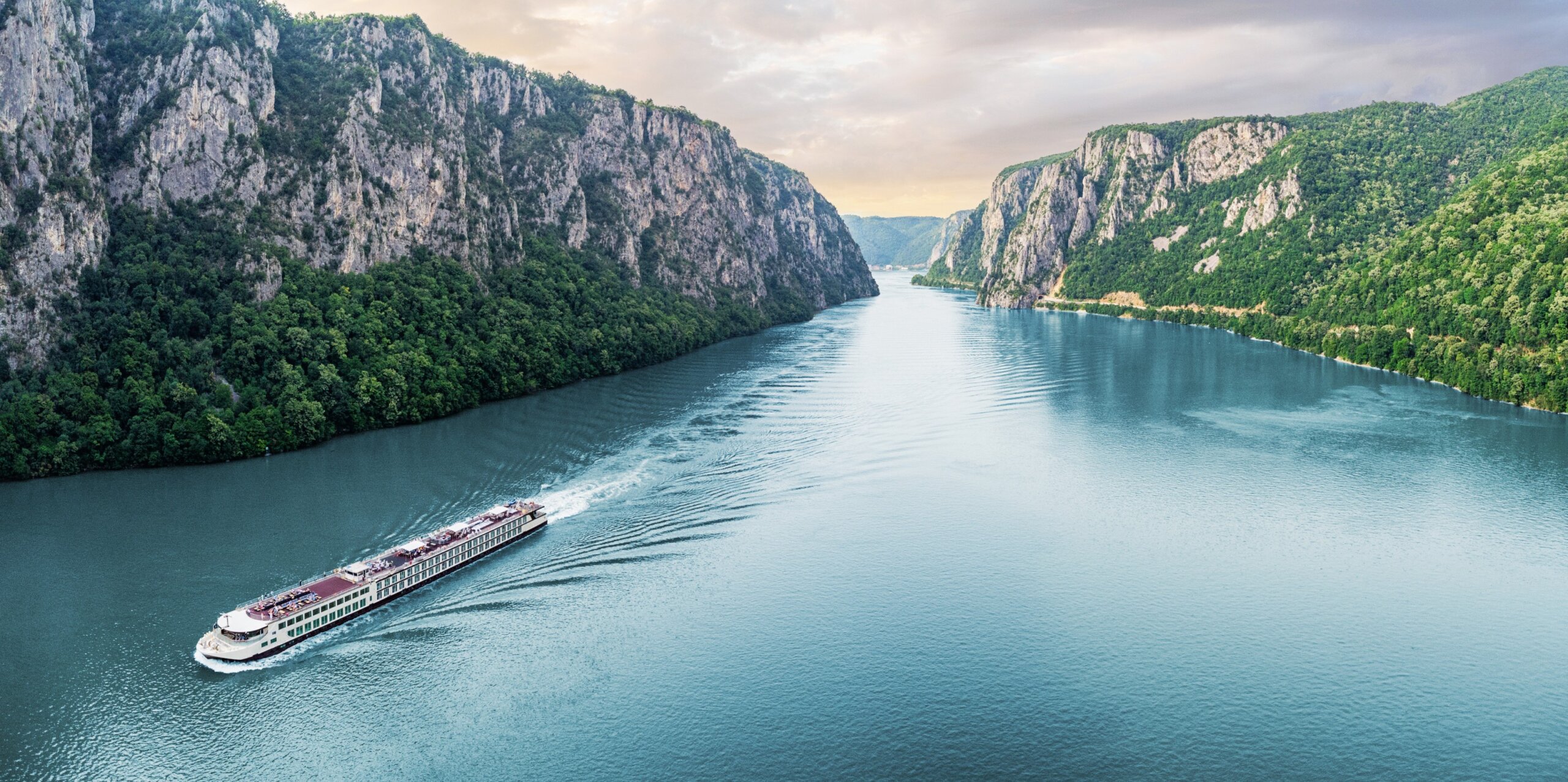 Scenic Cruise Line Passenger vessel cruising through the picturesque Iron Gate Gorge on a summer vacation trip