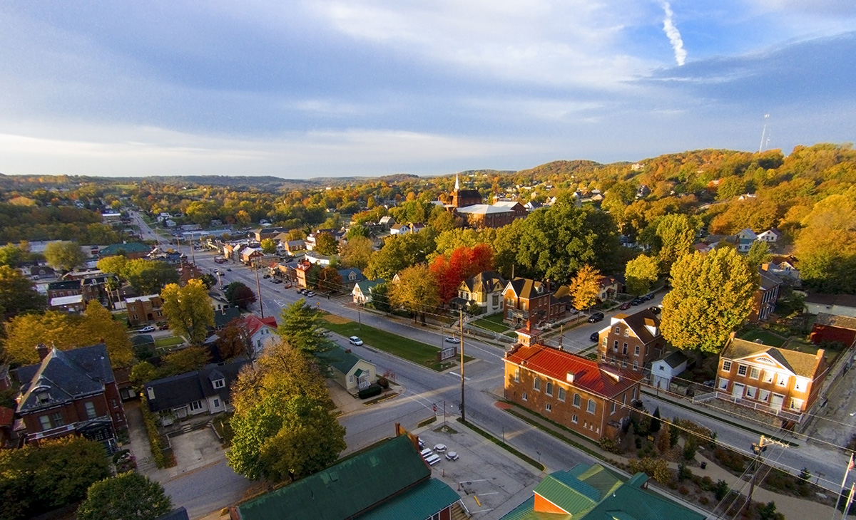 Aerial view of Hermann, Missouri in autumn with colorful fall foliage, historic buildings, and scenic countryside along the Amtrak Missouri River Runner route.