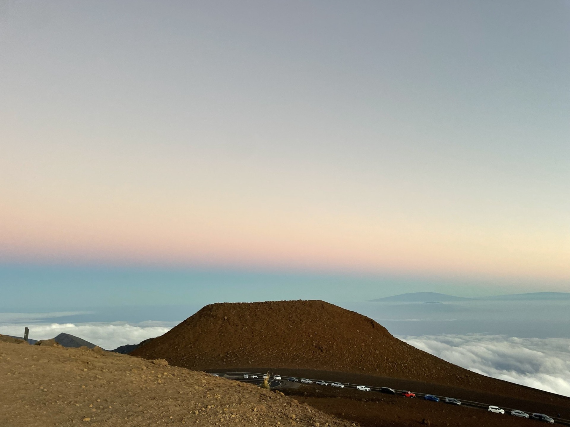 Views of Haleakala at sunset and other peaks in the distance.
