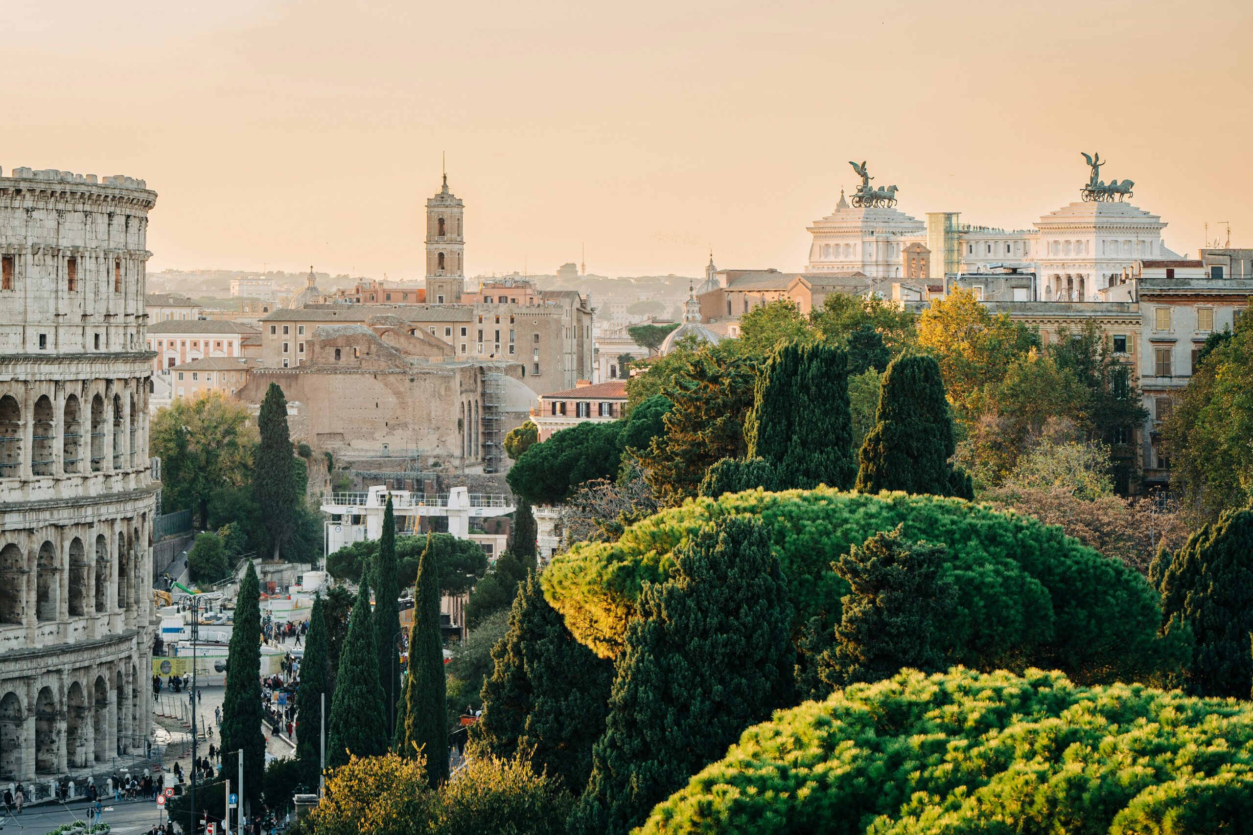 Sunset view of Rome with the Colosseum and historic skyline, symbolizing Italian travel tips and cultural traditions.