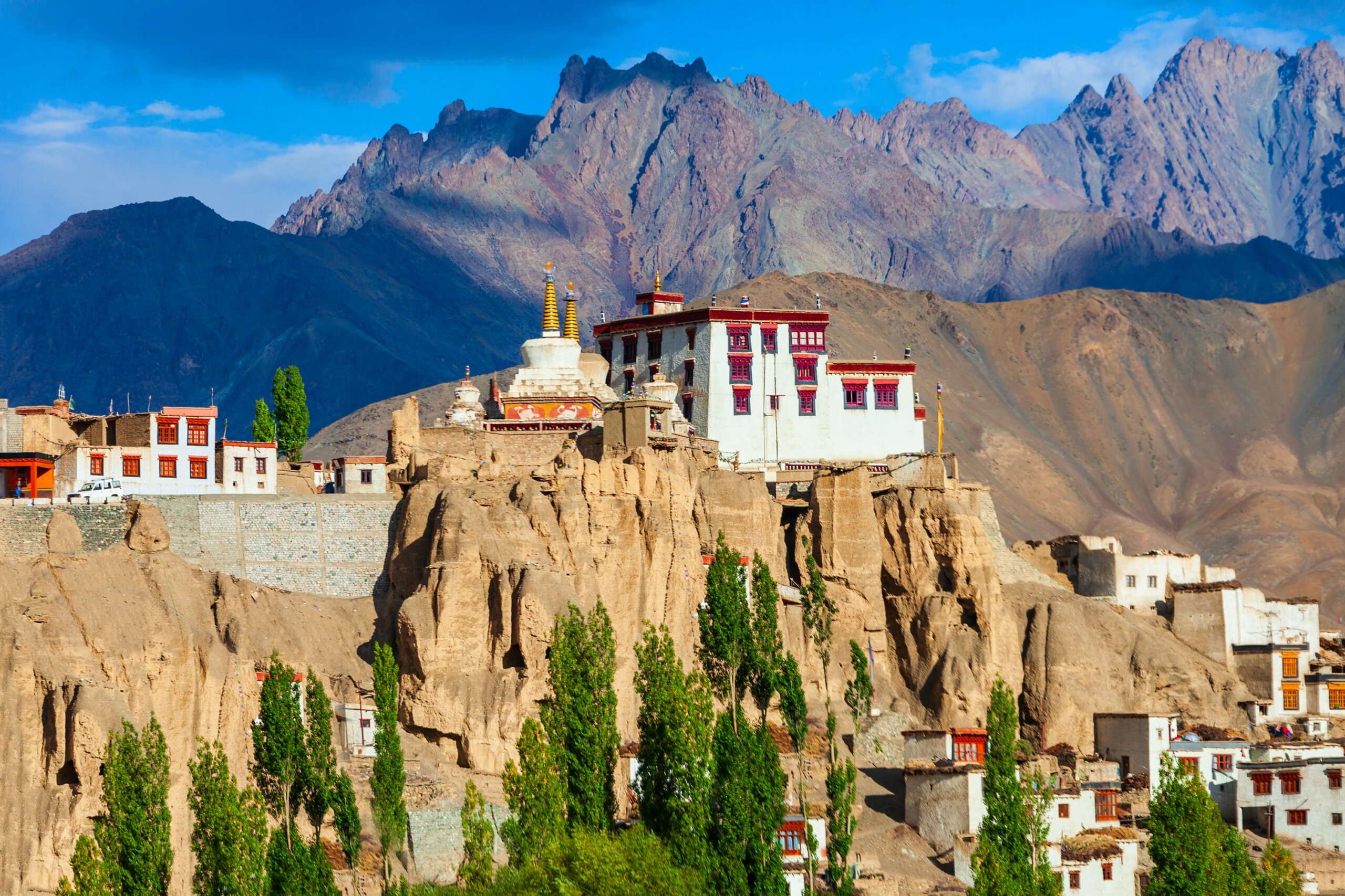 Buddhist monastery in Ladakh perched on a cliff with the Himalayas in the background — a spiritual and cultural highlight when traveling in India.