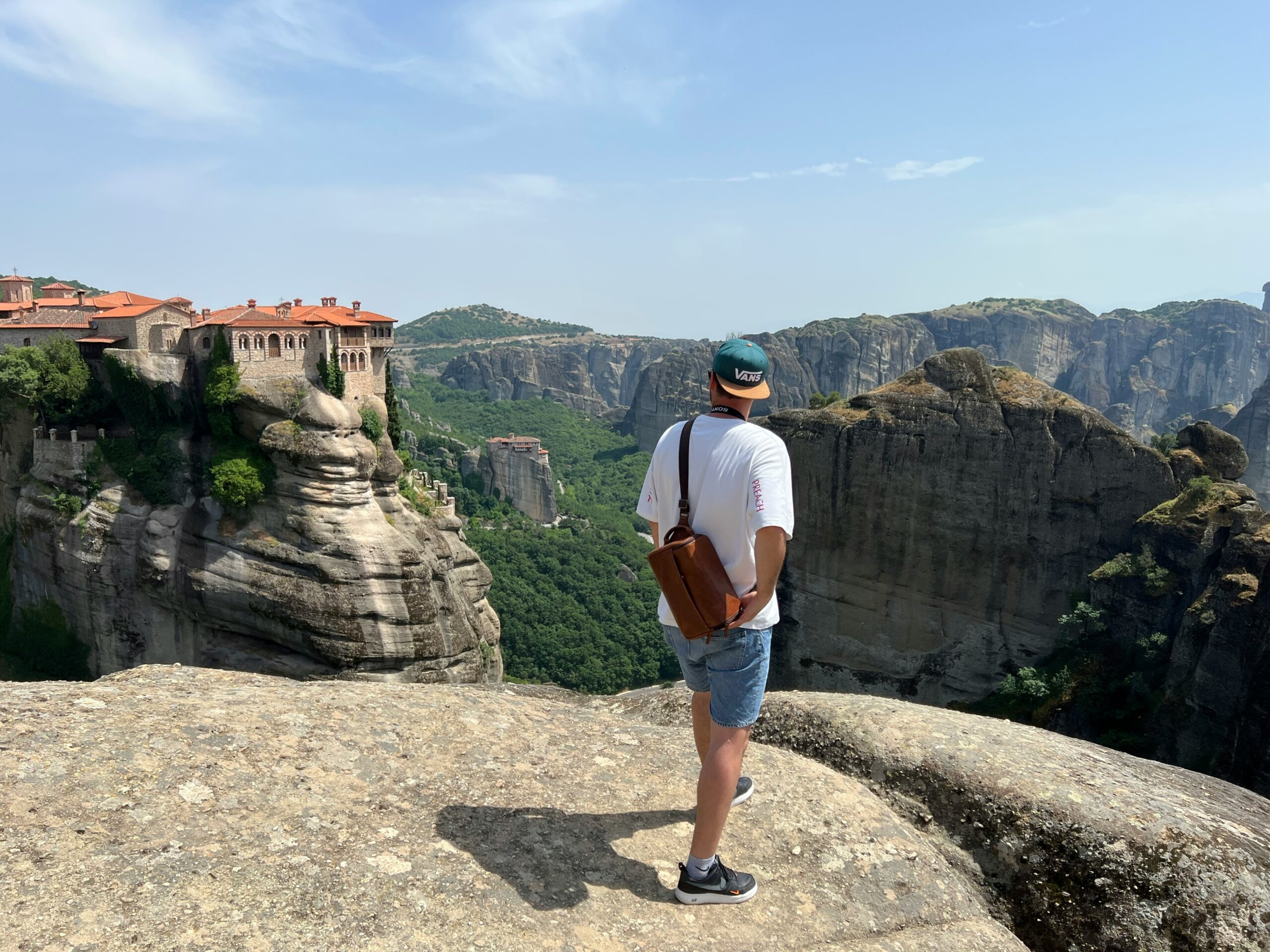 Traveler overlooking Meteora Monasteries in Greece, a UNESCO World Heritage Site and one of Europe’s most sacred spaces.
