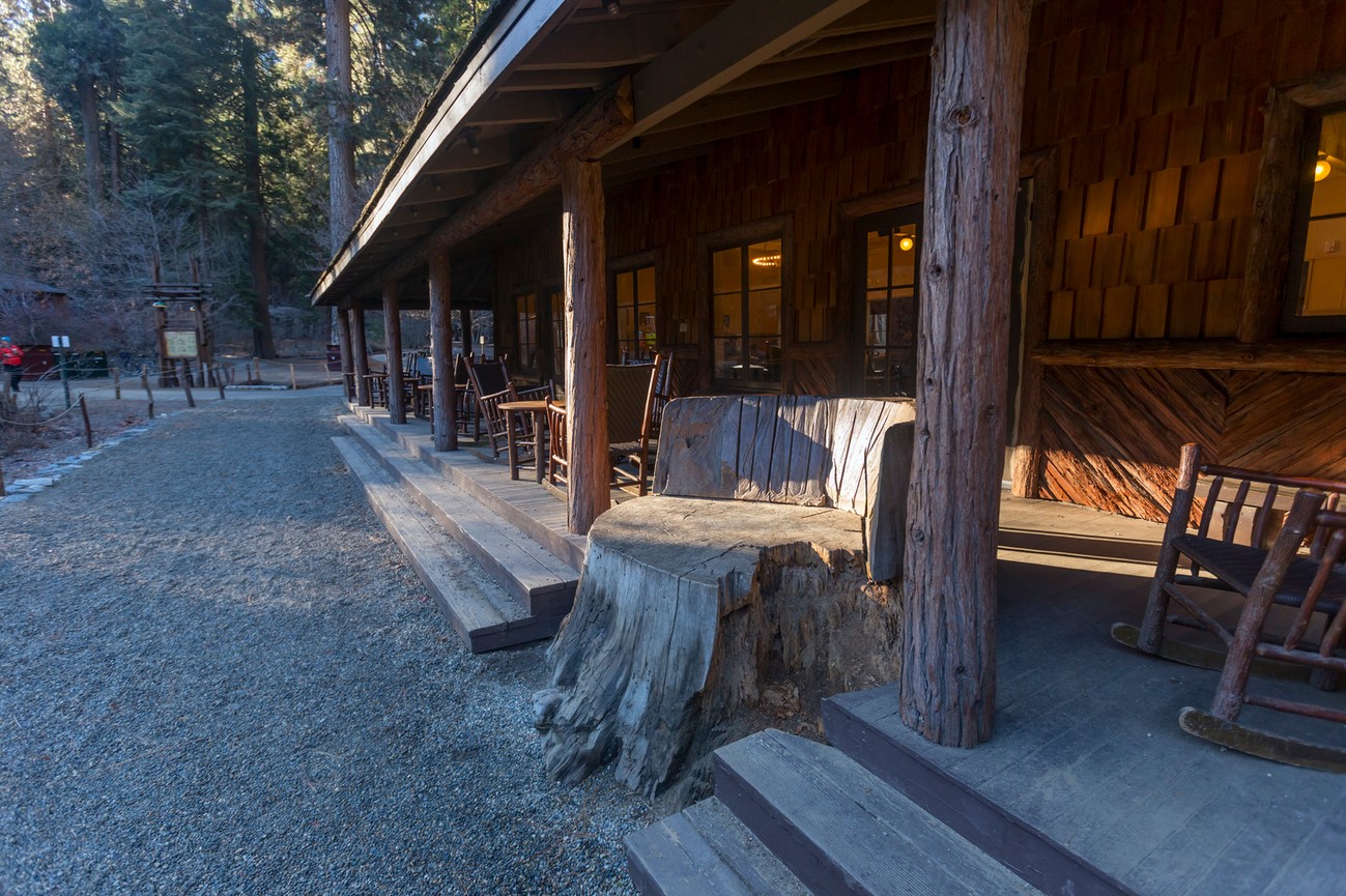 Rustic wooden lodge and outdoor seating at Curry Village in Yosemite National Park, a popular spot with tent cabins and social activities