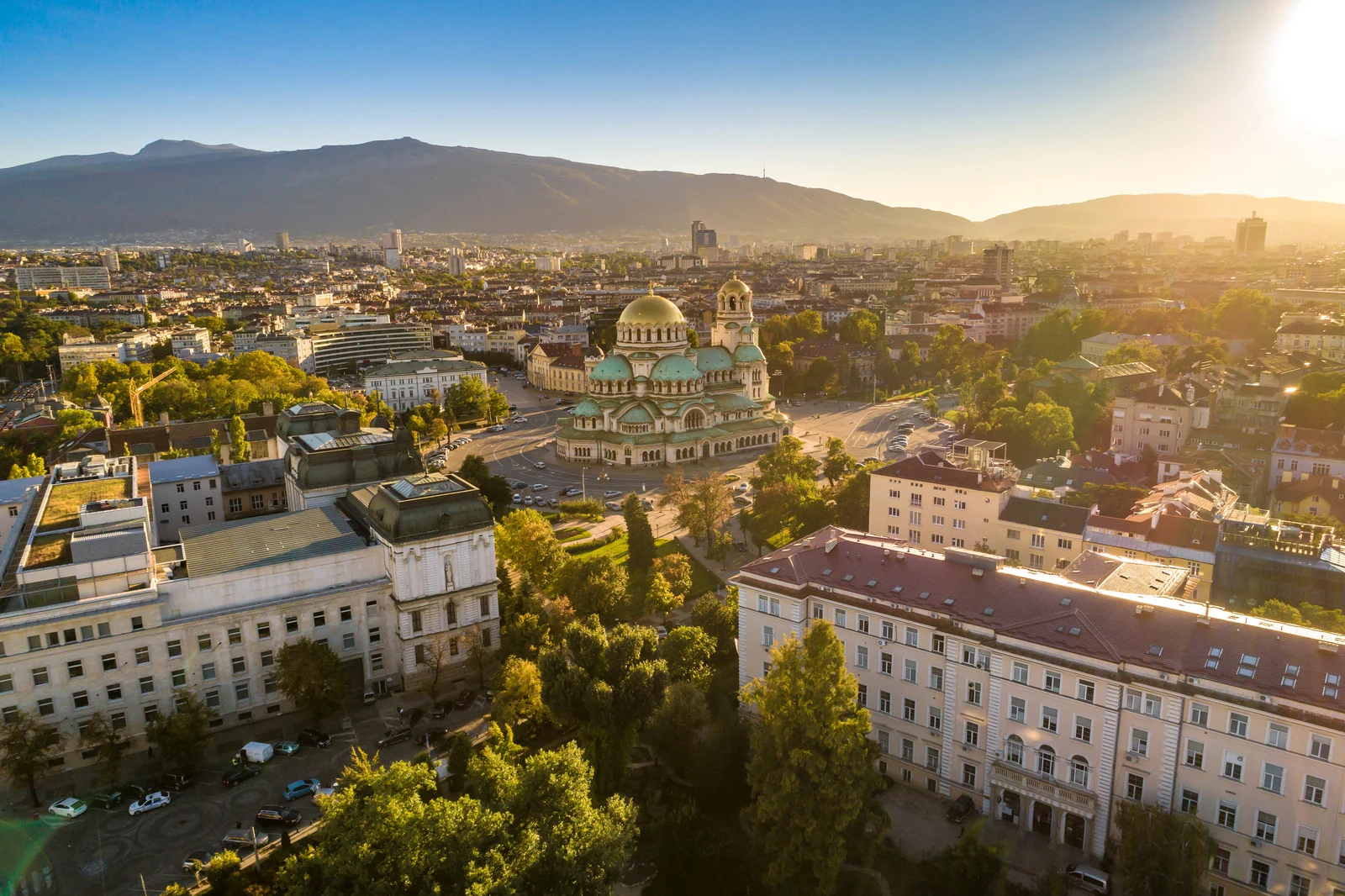 Sofia cityscape with Alexander Nevsky Cathedral and mountains in the background at sunset, Bulgaria.