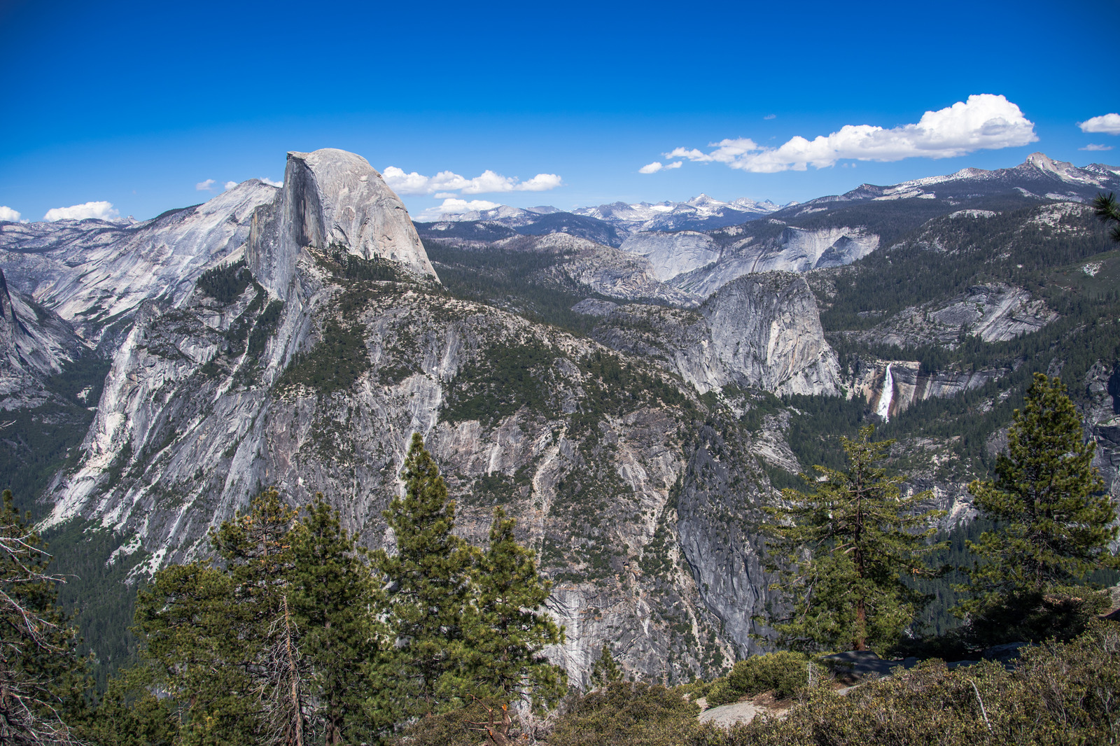 Panoramic view of Half Dome and Yosemite Valley from Glacier Point Road overlook in Yosemite National Park