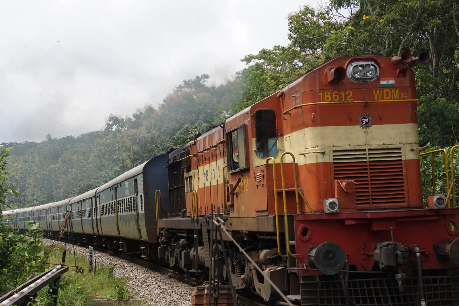 Indian sleeper train traveling through lush countryside — an authentic way to explore India and experience long-distance journeys across the country.