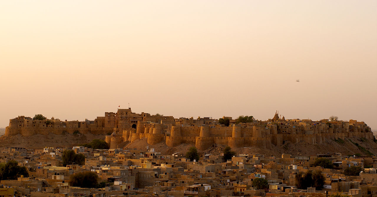 The Jaisalmer fort, also known as Sonar Qila or the Golden fort after its luminous golden sandstone, is the second oldest fort in Rajasthan after Chittorgarh. Founded by Maharawal Jaisal in 1156 AD and built atop the 250 ft high Tricuta or Gorhara hill south of Jaisalmer, the magnificent crenelated edifice protectively towers over the city roughly running east to west.