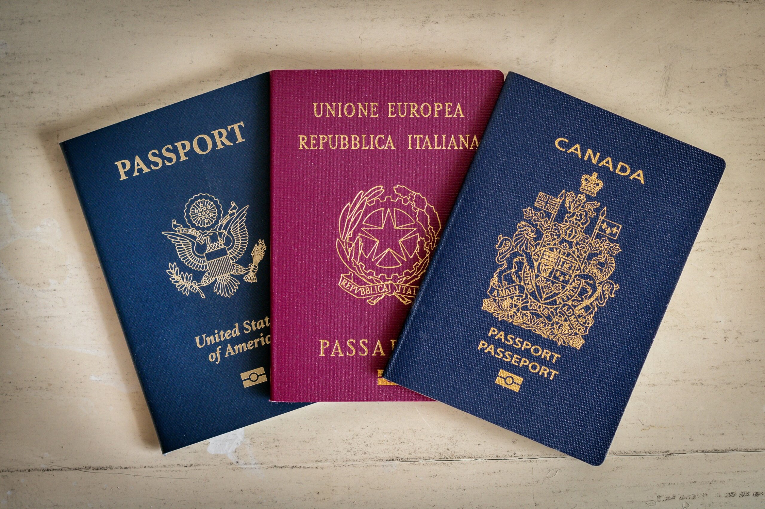 American, Italian and Canadian passports lying on table