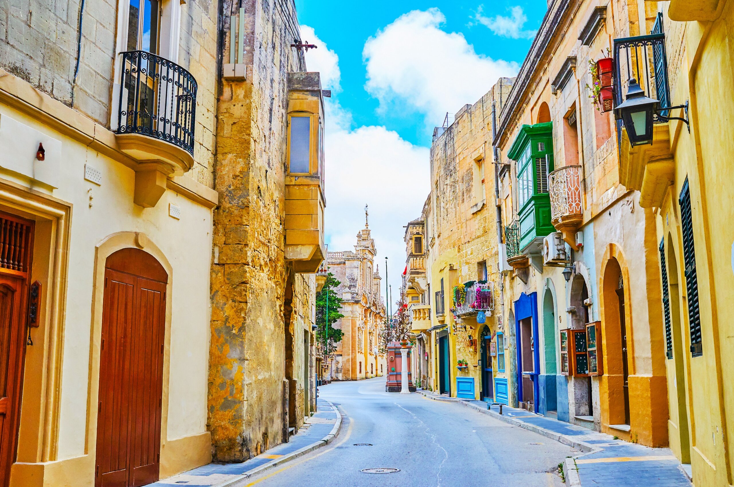 Narrow St Paul street and St Paul Parish Church on the background in Rabat, Malta
