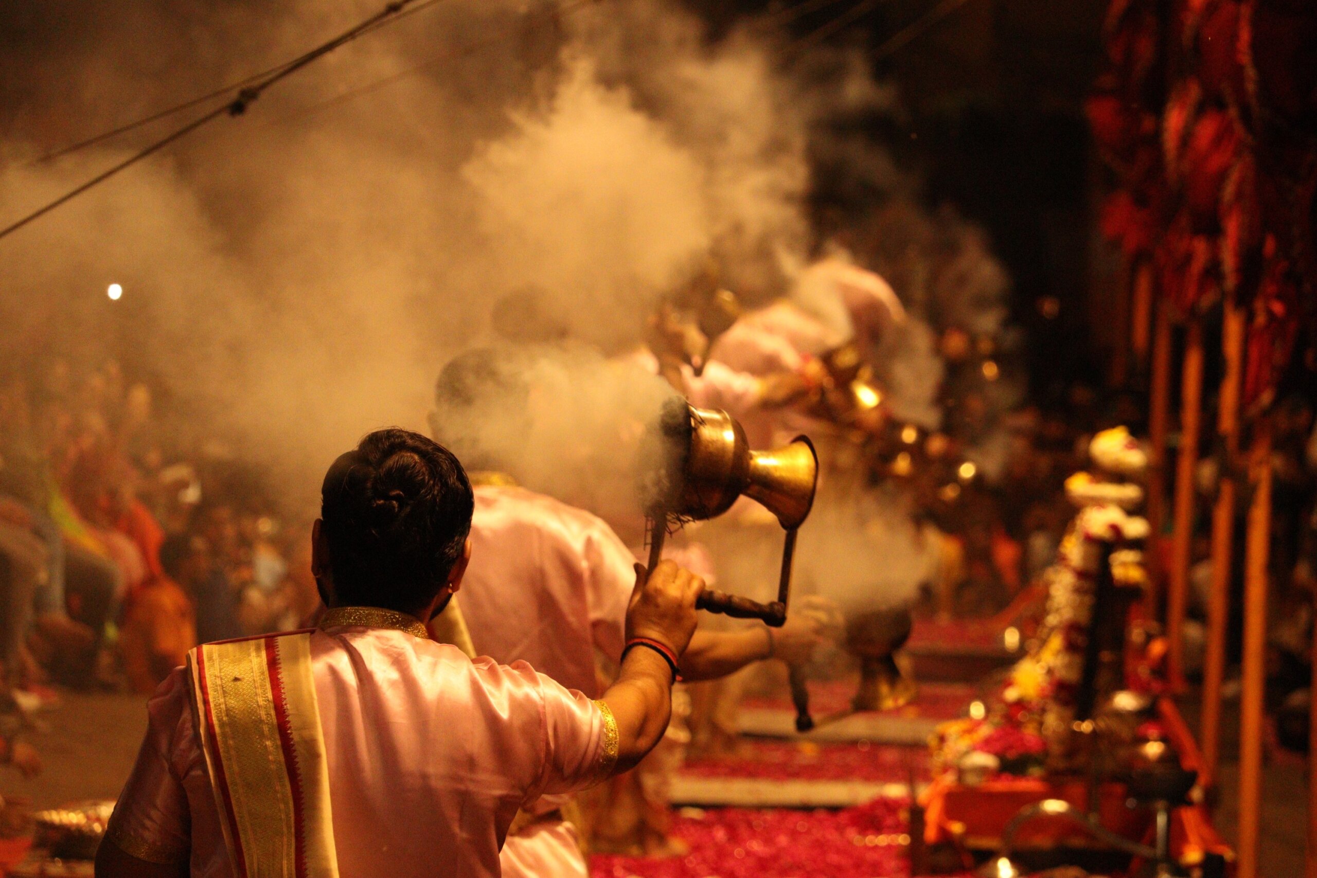 Varanasi India 30 Jan 2022 Ganga aarti ceremony rituals performed by Hindu priests at Dashashwamedh Ghat in Varanasi with selective focus. housands of diyas (oil lamps) are lined up on the stairs.