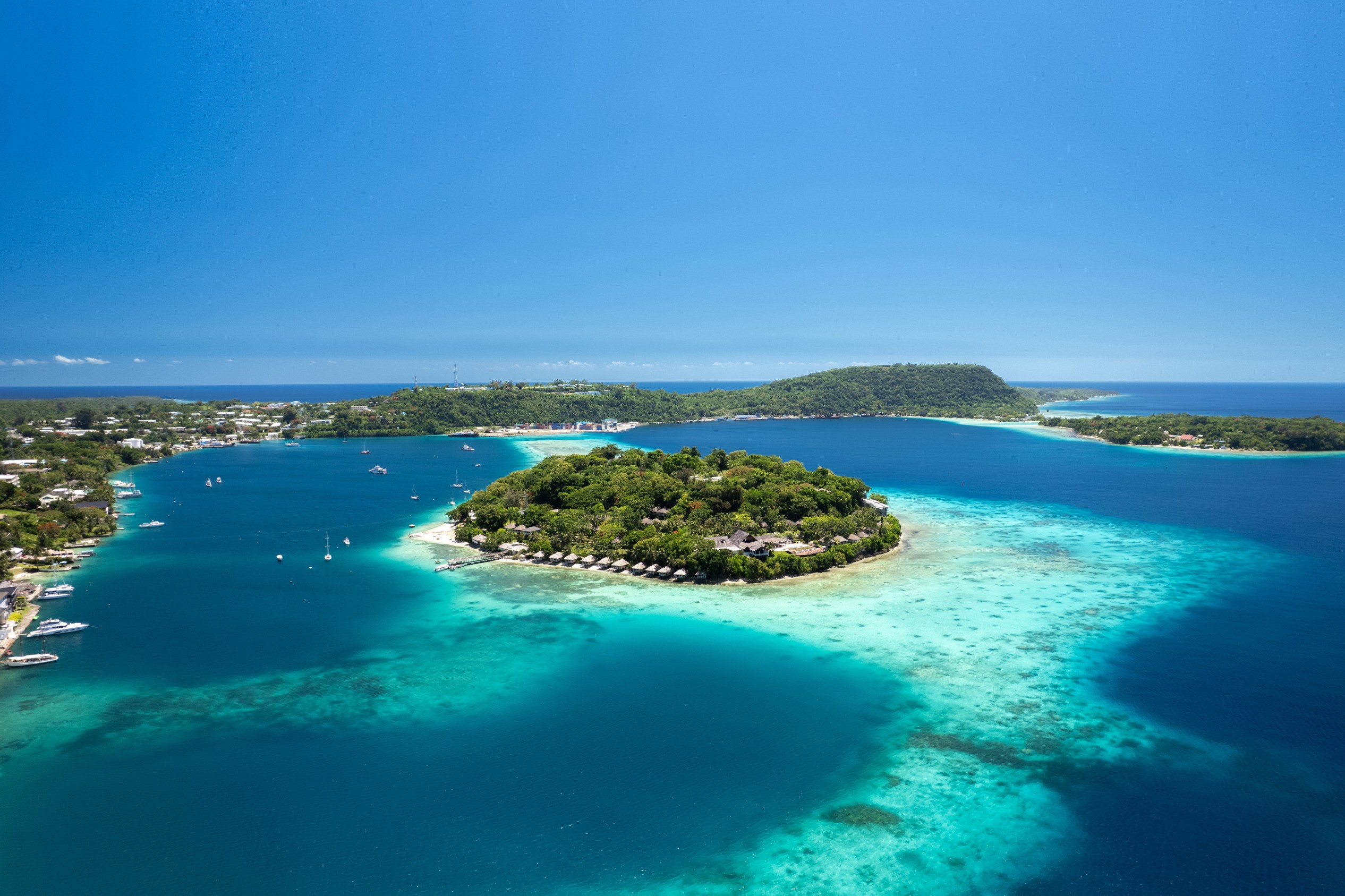 Drone photo of Iririki Island resort in Port Vila Harbour, Vanuatu. Idyllic holiday destination with clear water, boats, and waterfront bungalows. - one of the world’s most earthquake-prone regions.
