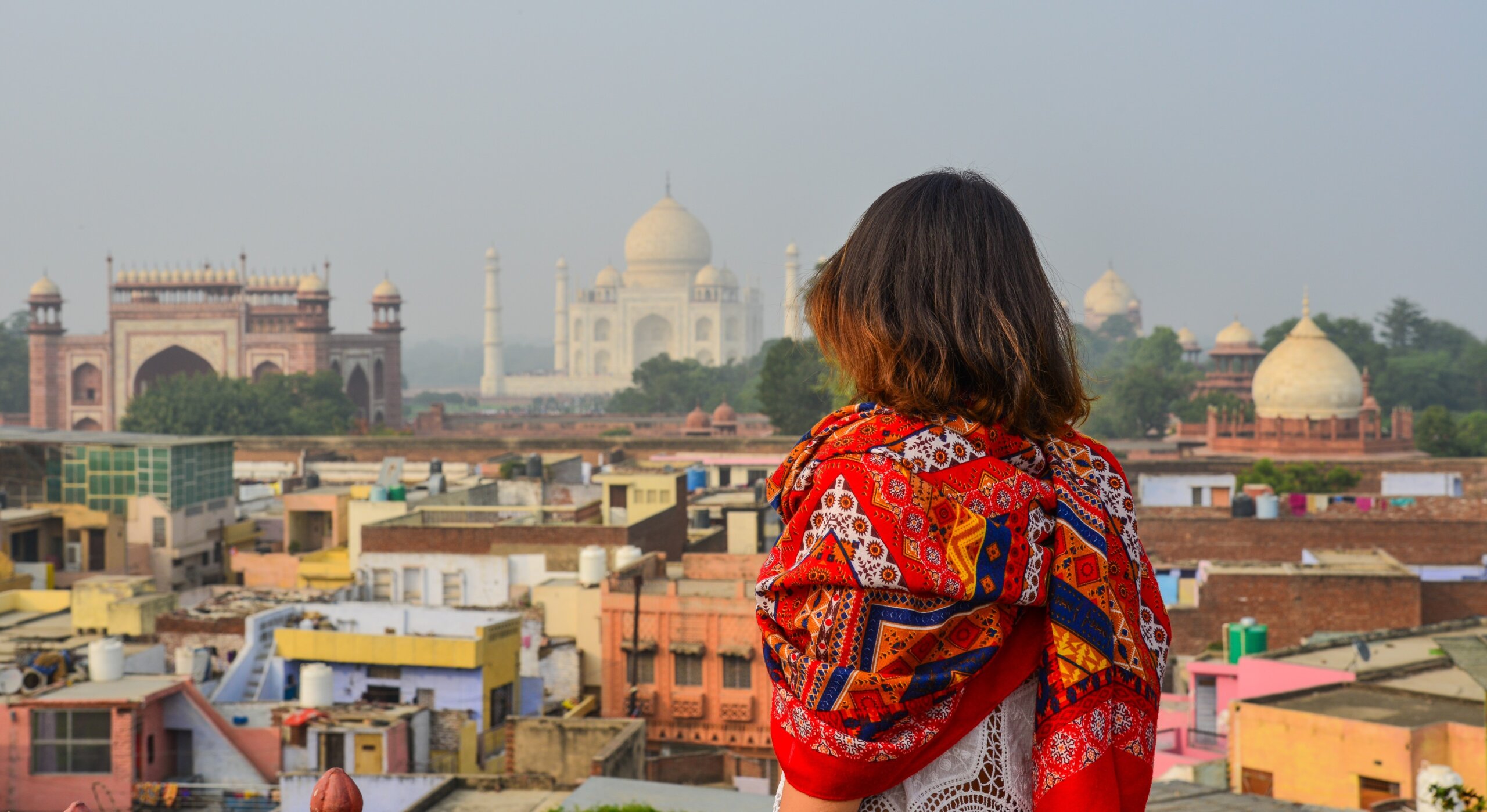 A young woman looking at Taj Mahal
