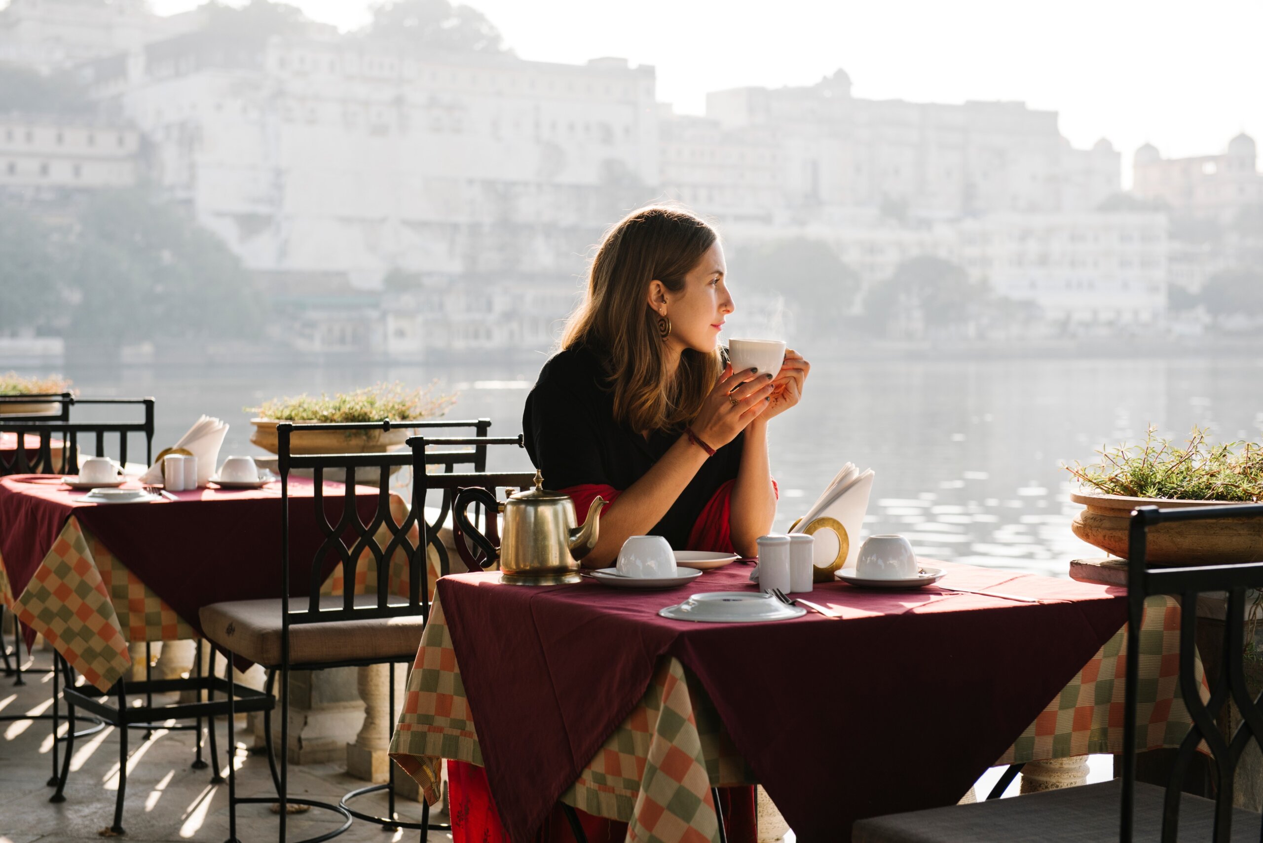 Western woman having a teatime at a cafe in Udaipur
