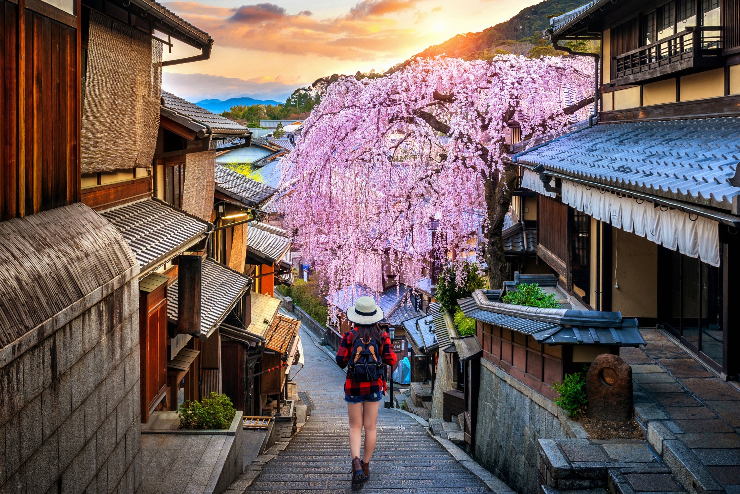 Woman traveler with backpack walking at Historic Higashiyama district in spring, Kyoto in Japan.
