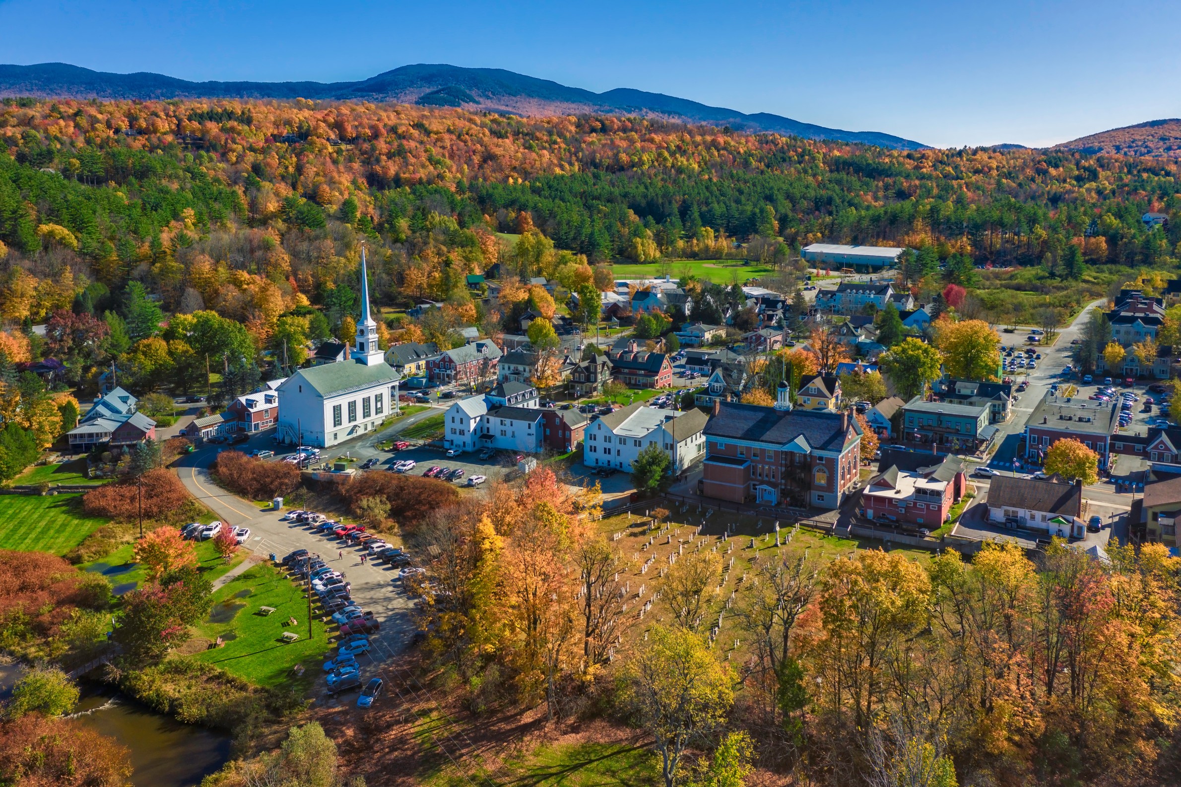 Aerial view of charming small town Stowe in Vermont. Mountains with fall multicolor trees
