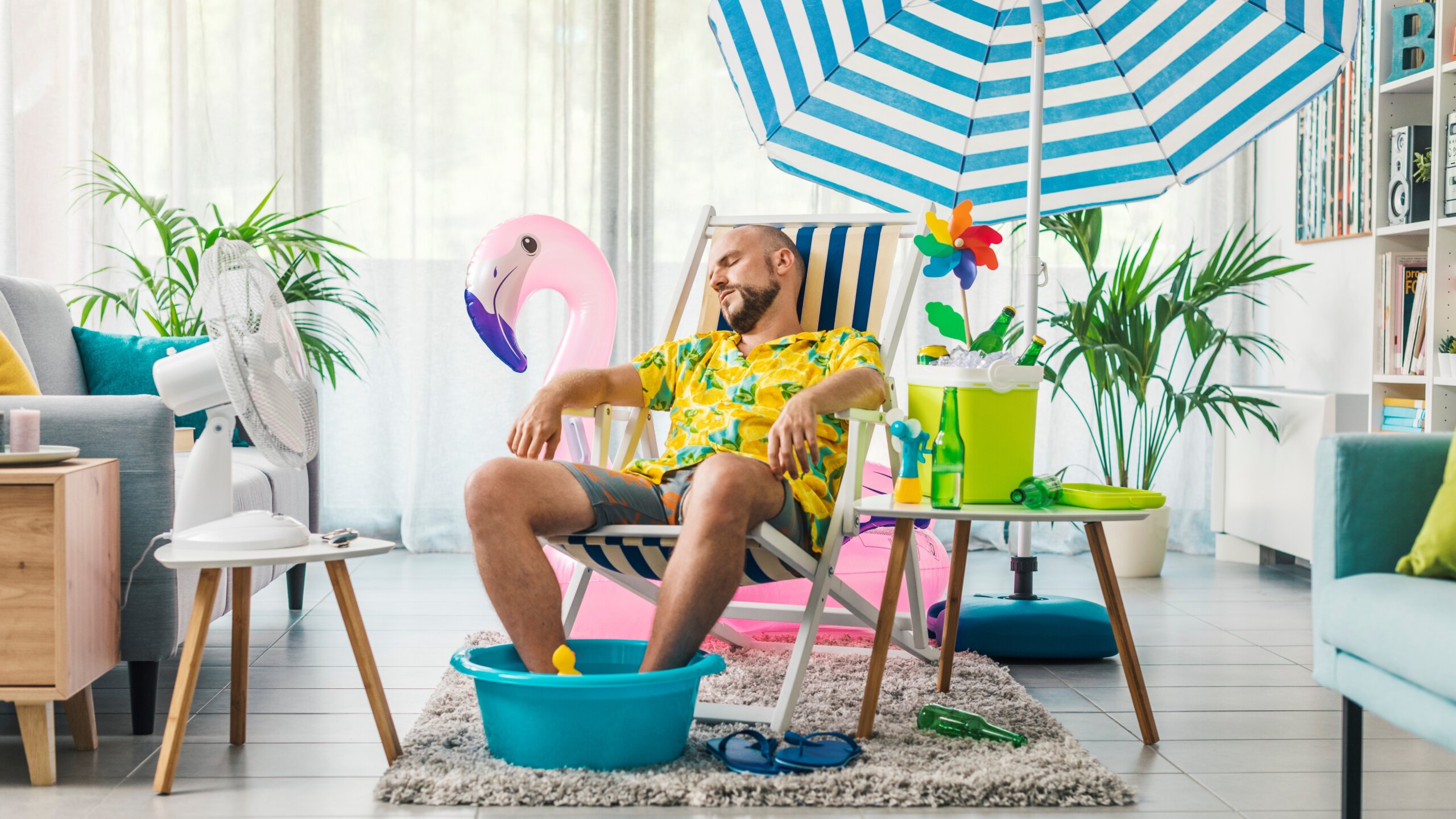 Man having a staycation and resting on a deckchair at home
