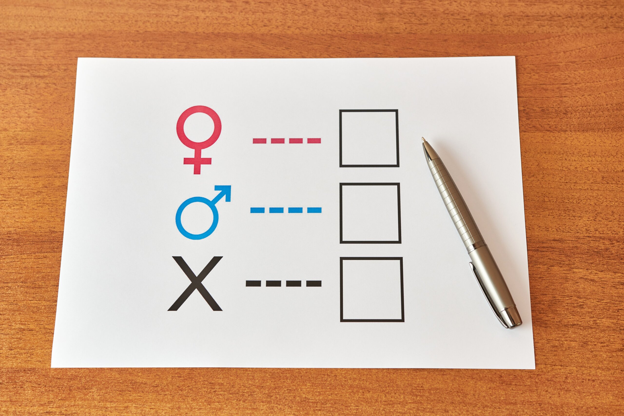 A person is determined by his gender. Sheet of paper with gender symbols. The right to one's identity.