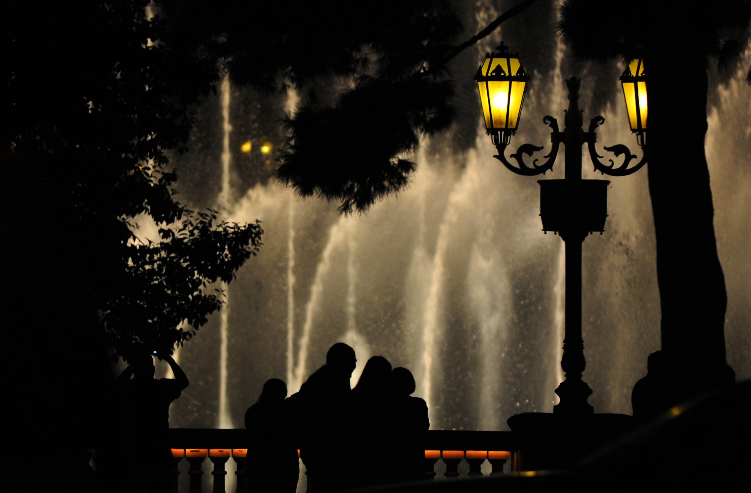 Silhouette of tourists watching a fountain show at night in Las Vegas, Nevada, southwest USA

