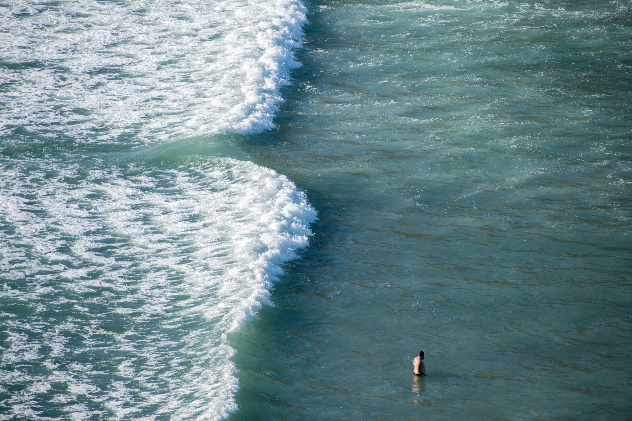 View of tourist bathing near dangerous rip current