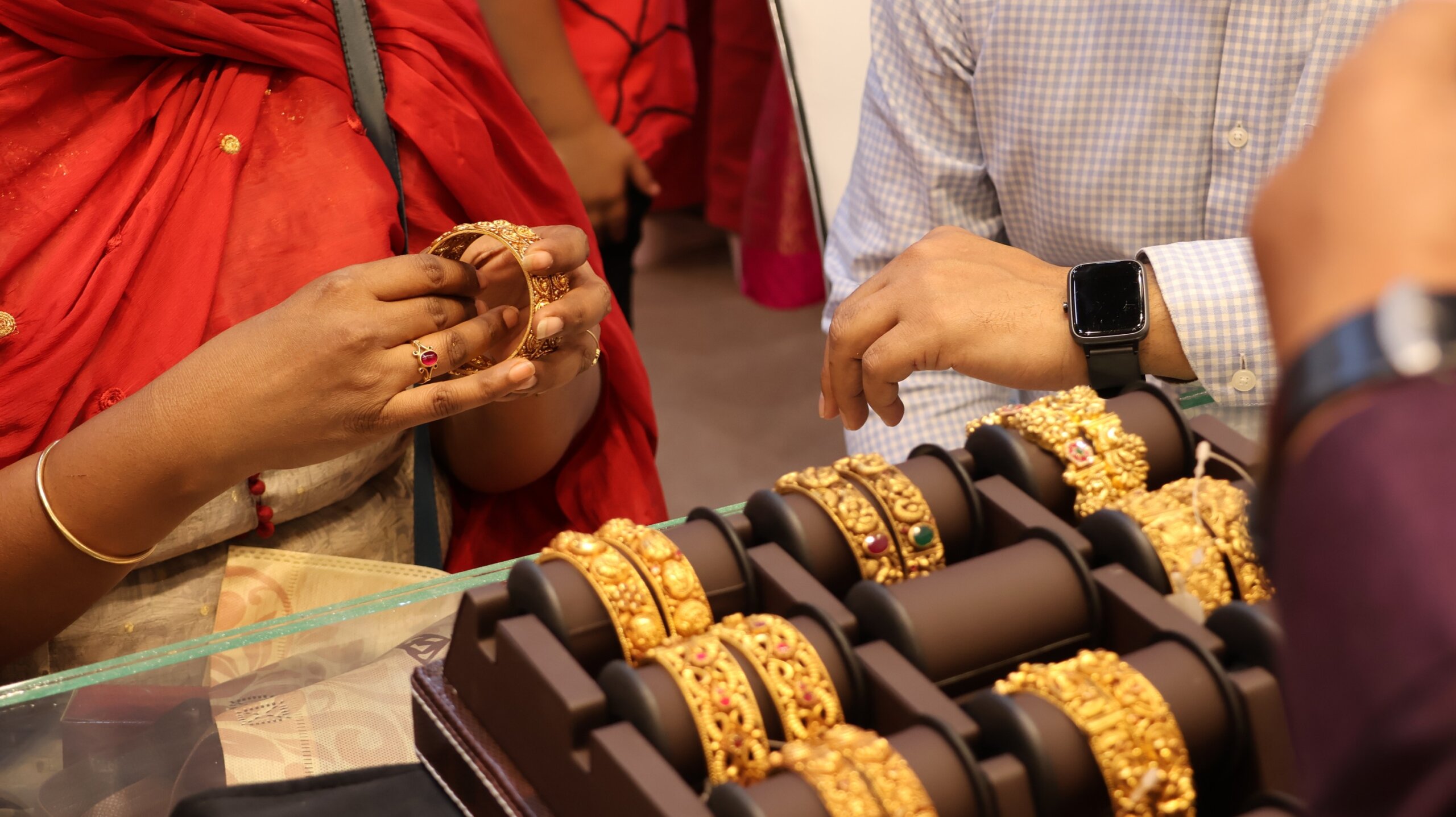  Indian customer in a jewellery exhibition buying gold on the occasion of Dhanteras and Vijayalaxmi. Traditional ornaments with marvelous stones and intricate designs.