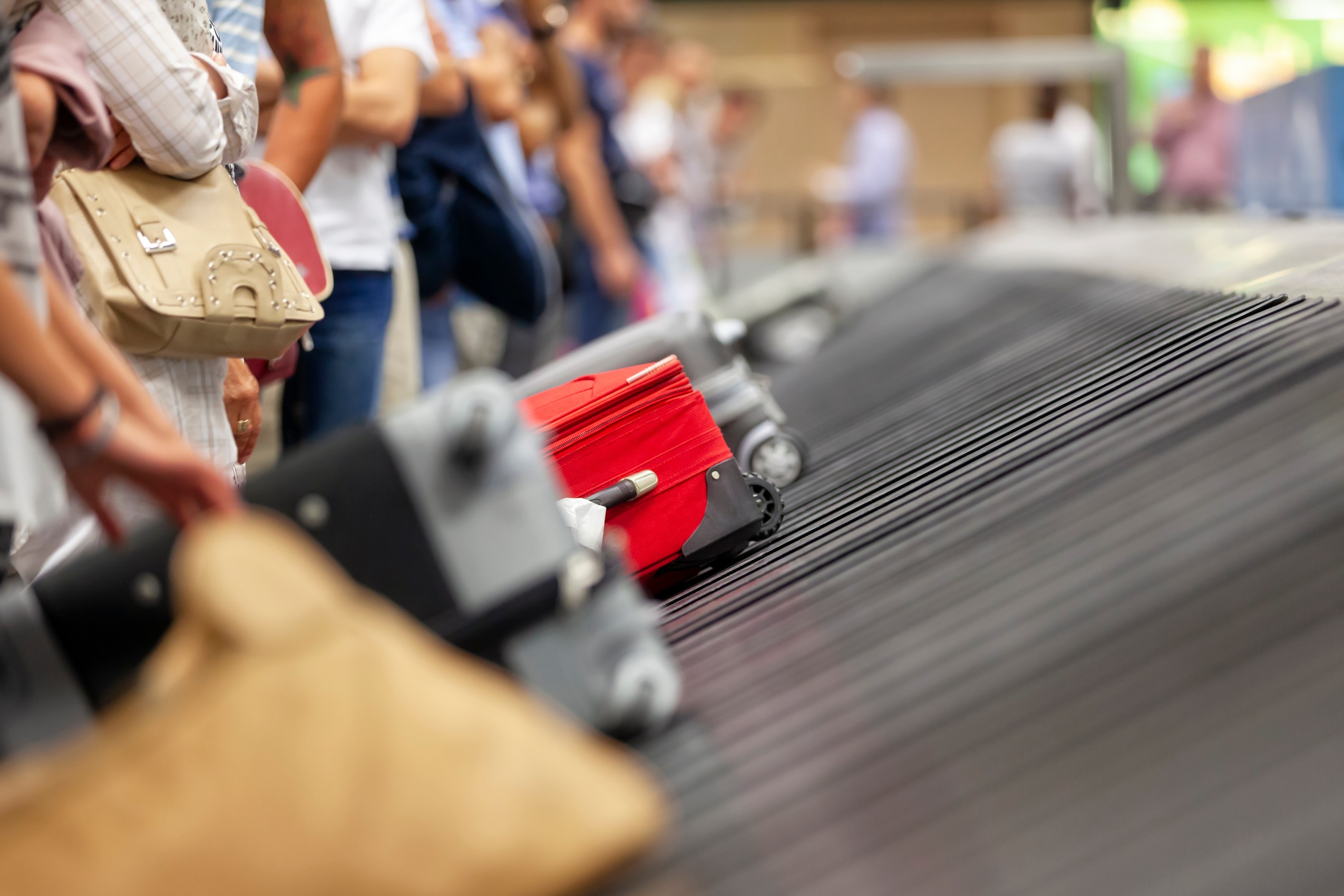 Baggage claim luggage conveyor belt with suitcase at airport
