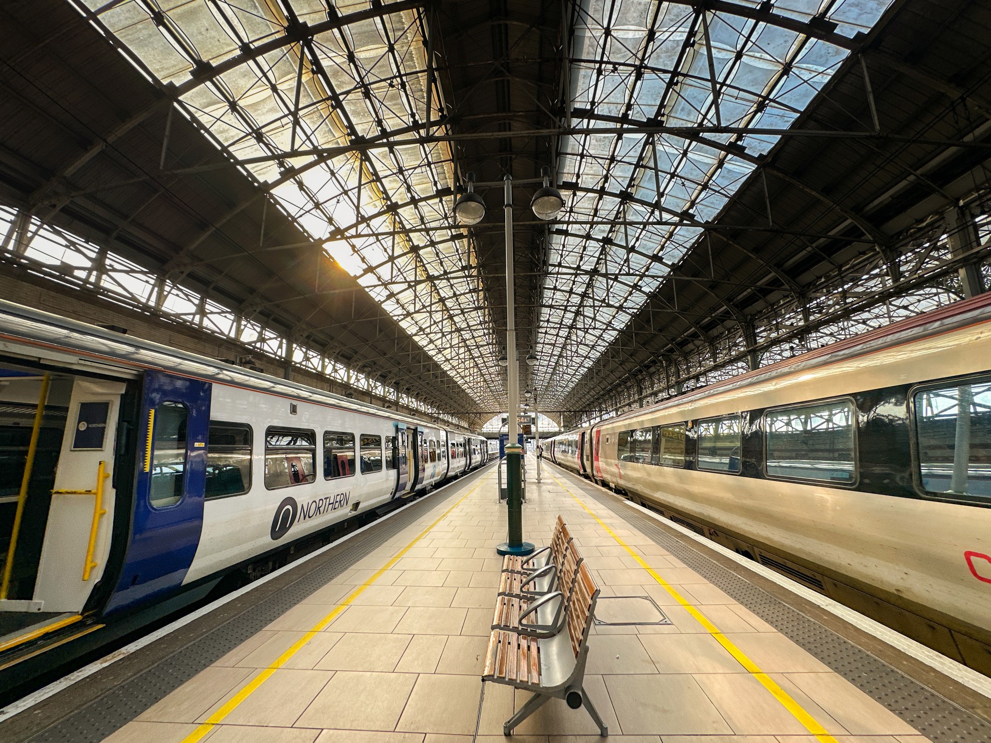 Manchester, England, UK - 31 May 2024: Wide angle view of trains operated by Cross Country and Northern rail companies alongside platforms at Manchester Piccadilly railway station