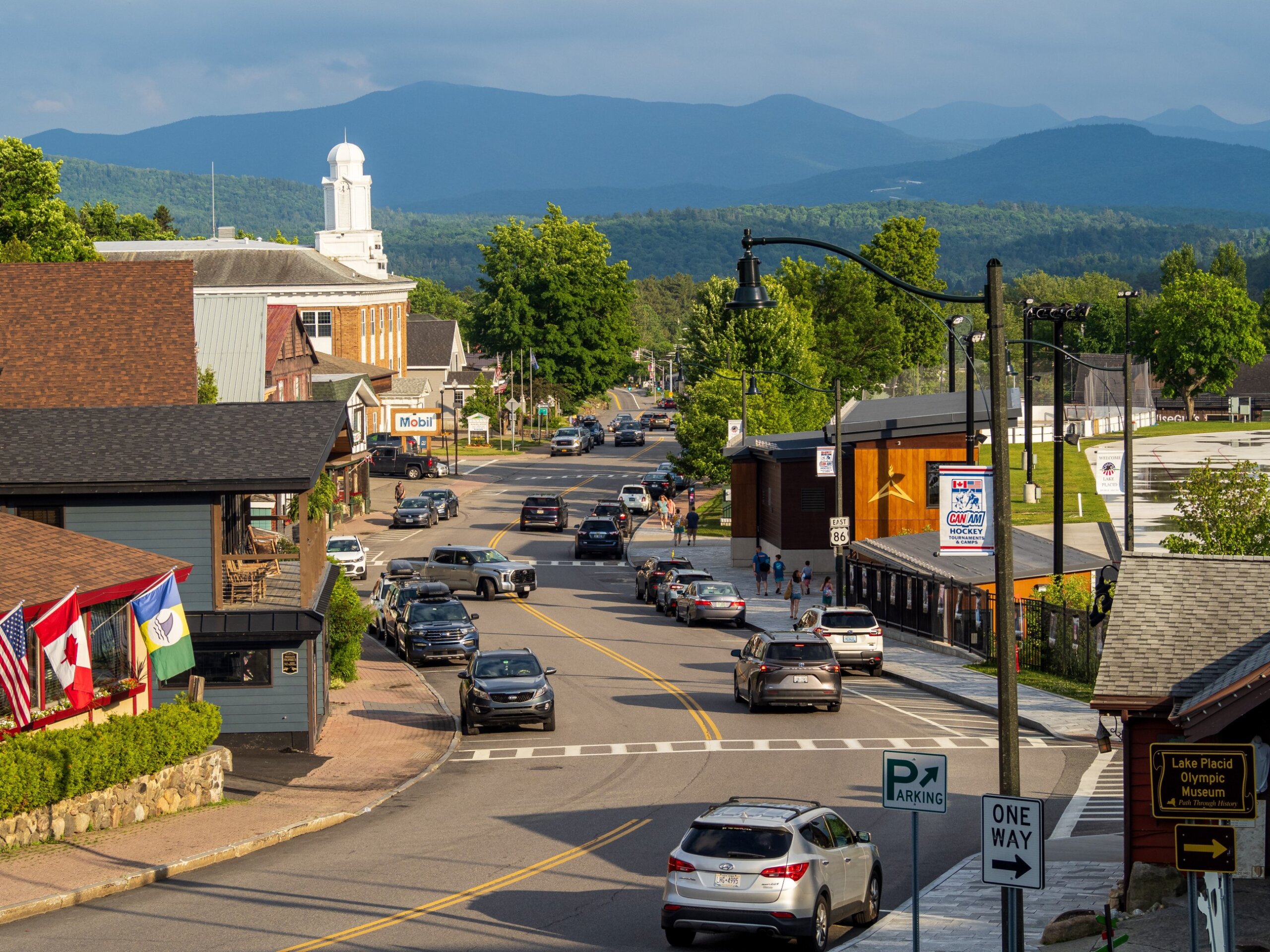 Main Street downtown Lake Placid on sunny day with mountains in the background in Upstate New York state, USA.

