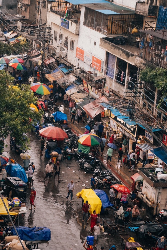 Chaotic streets of Delhi full of rickshaws, Ubers, bikes and people. 
