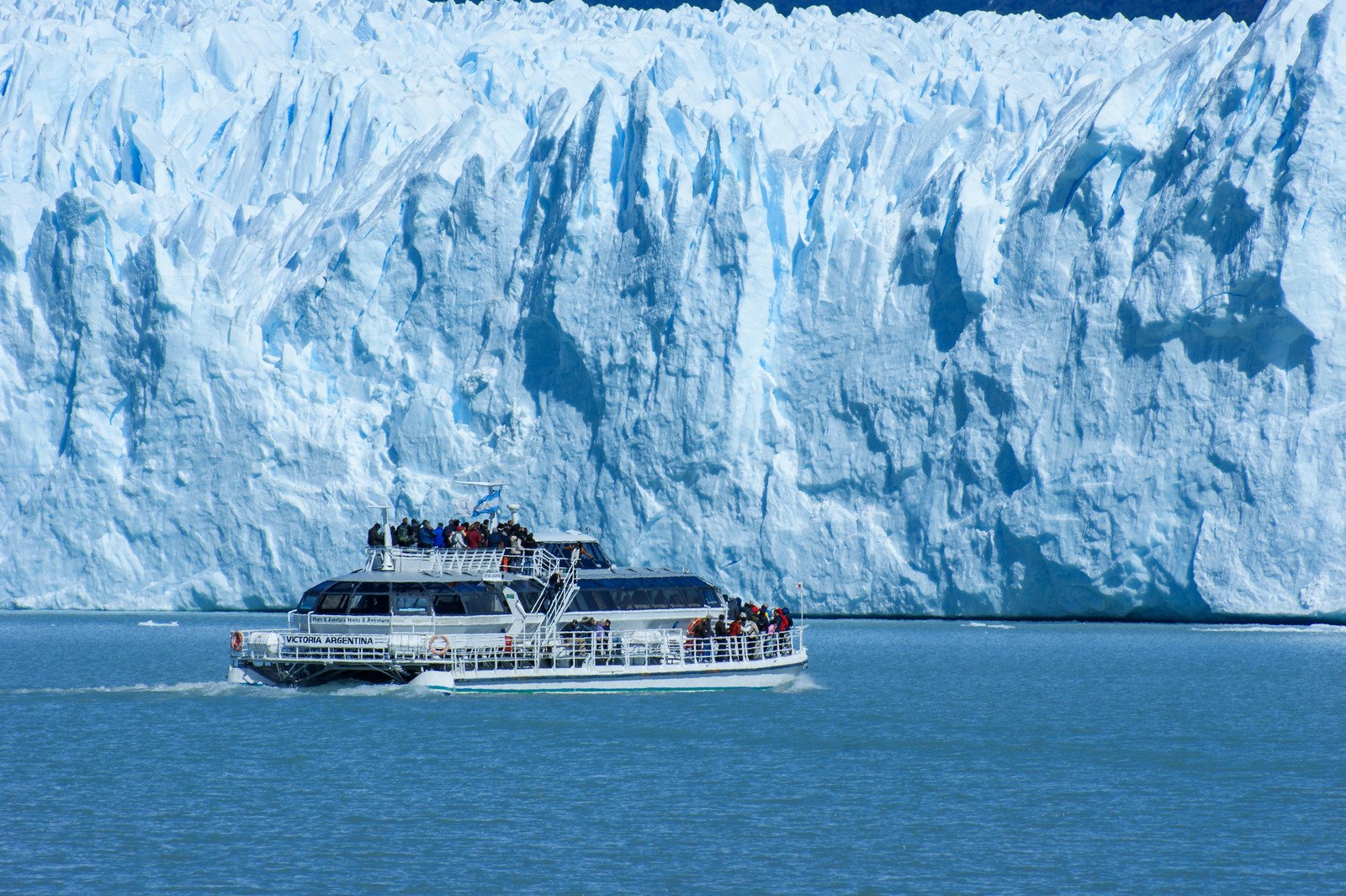 Boat sailing past glaciers in Patagonia — a breathtaking adventure for middle-class retirees.