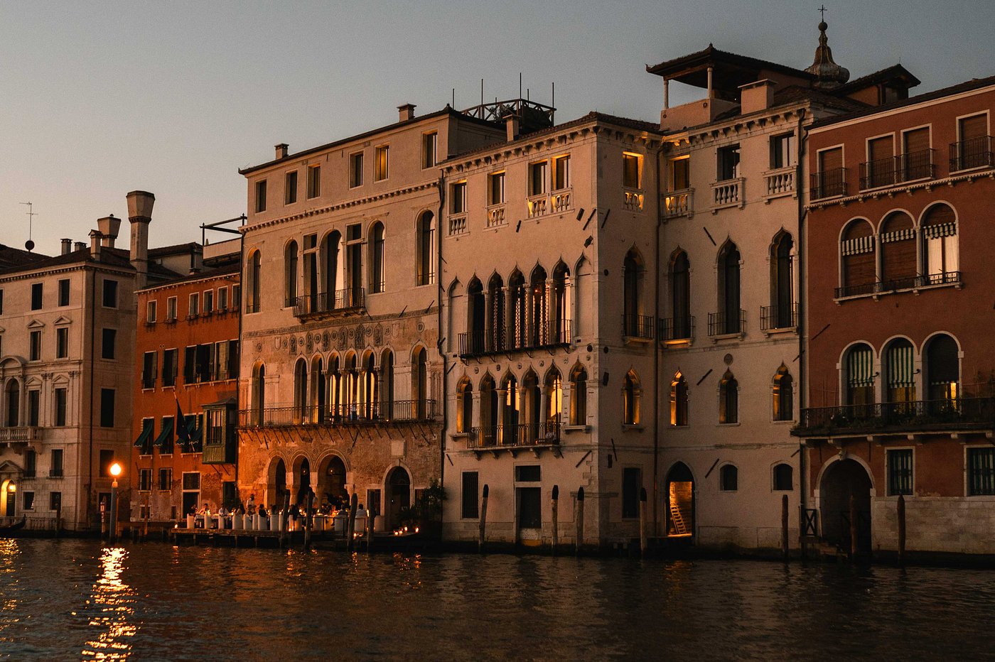 Sunset view of The Venice Venice Hotel on the Grand Canal, a luxury art-forward stay near Rialto Bridge.